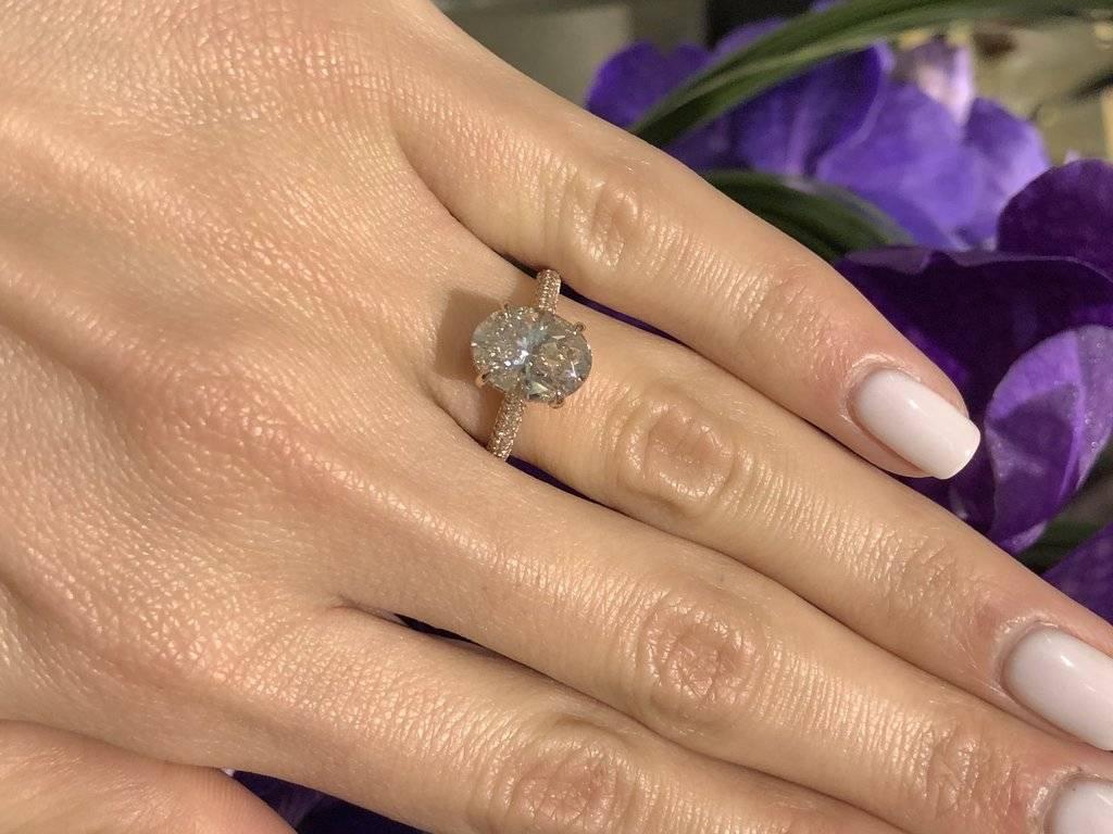 Rose gold has been the top selling color lately and we can see exactly why with this gorgeous 3.71 ctw 14k rose gold ring. This beauty is a showstopper! Featuring an incredible 3.03ct oval cut diamond that is GIA certified at K-SI2. Perfectly set in