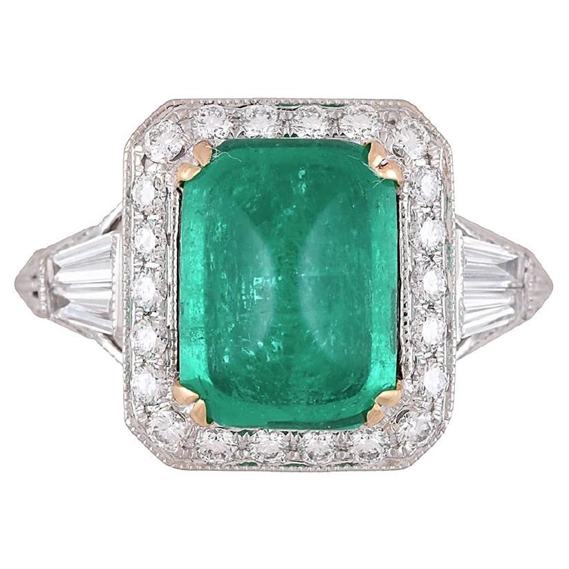 Elegantly designed, this breathtaking ring features a striking 3.71 carat cushion Sugarloaf Cabochon Emerald at its center, which is GIA Certified for your assurance. Complementing the emerald's beauty are 1.15 carats of pristine natural diamonds,