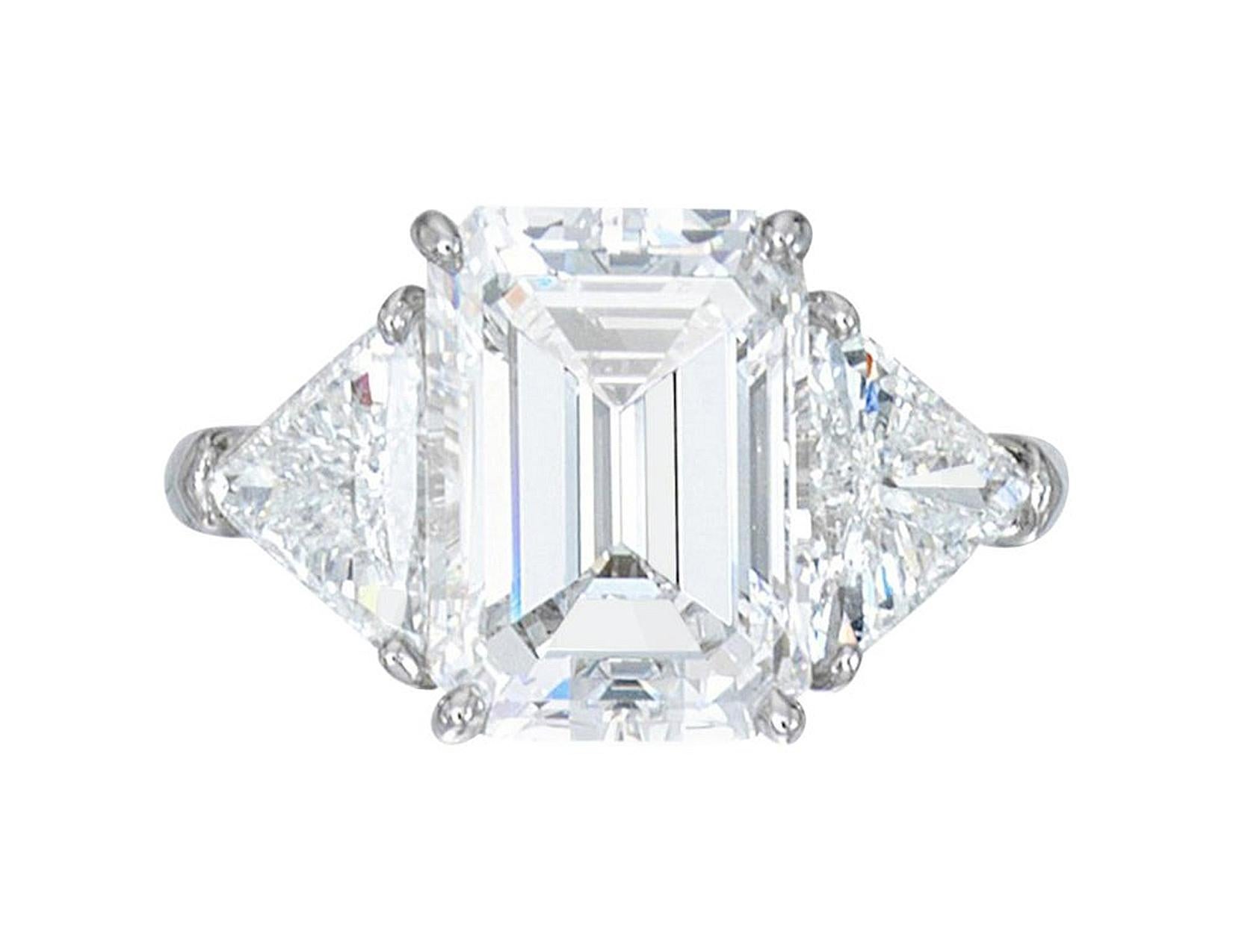 This exquisite ring features a 3.81 carat emerald cut diamond, GIA certified for its exceptional quality and craftsmanship. 

With an E color grade, the diamond is nearly colorless, showcasing a crisp and icy brilliance. 
The diamond's color grade