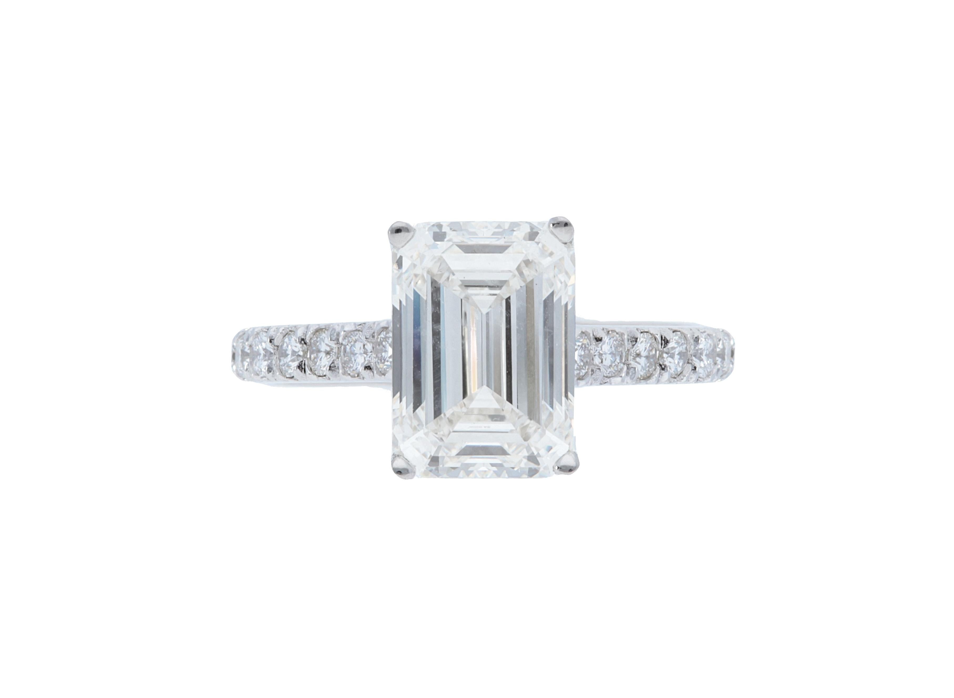 A Sofer Jewelry original piece. GIA certified 3.18 carat I SI1 emerald cut diamond set in platinum ring with 0.56 carats of white diamonds. Size 5.5.