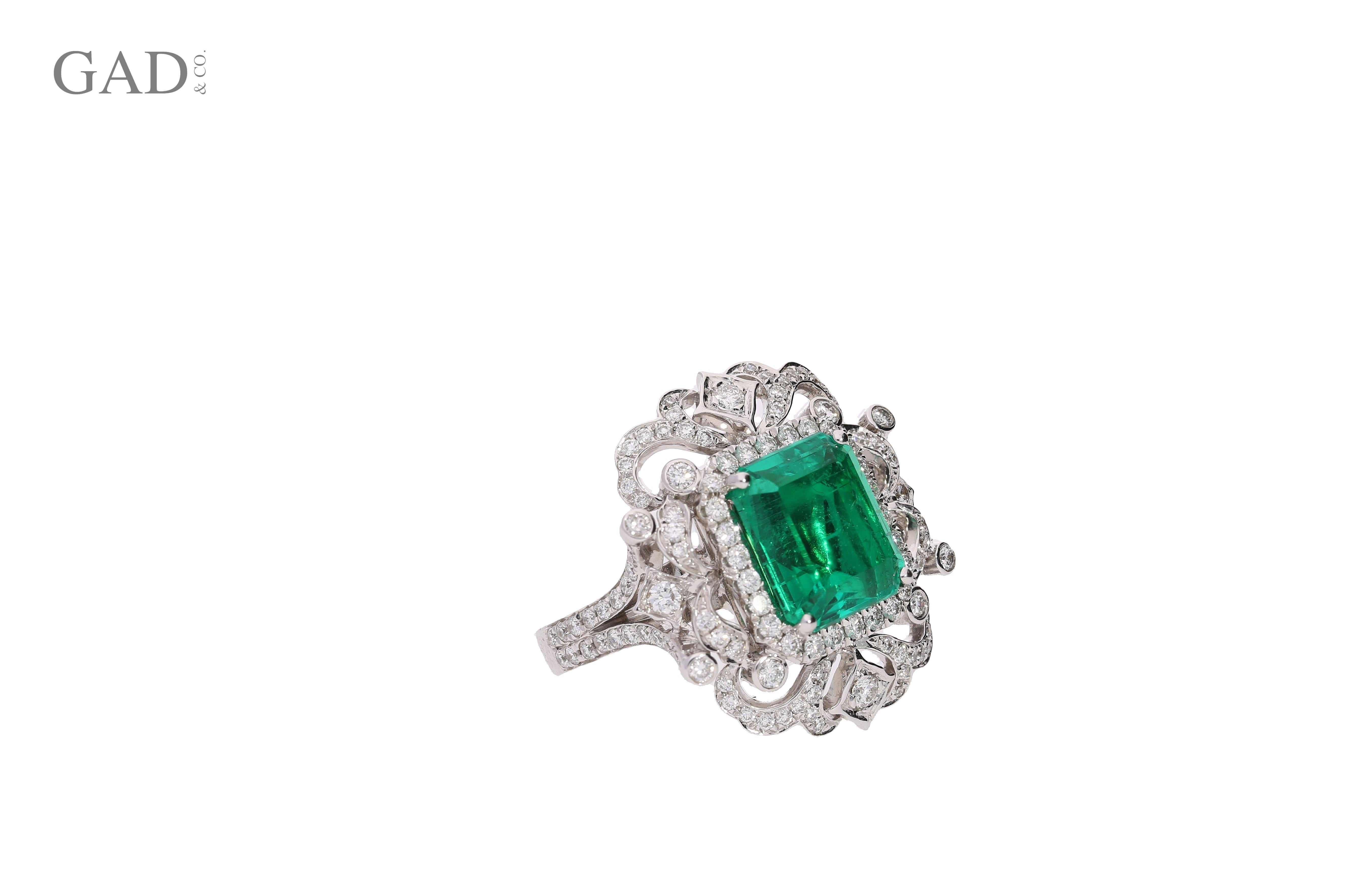 18k white gold Art Deco inspired cocktail ring mounts this vibrant GIA certified 3.75 carat Colombian Emerald center stone and 156 round cut diamonds of 1.35 carats total. The Emerald bears excellent luster and crystal, with a clean face that