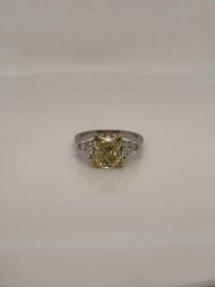 GIA Certified 3.75 Carat Cushion Cut Fancy Light Yellow Diamond Three-Stone Ring