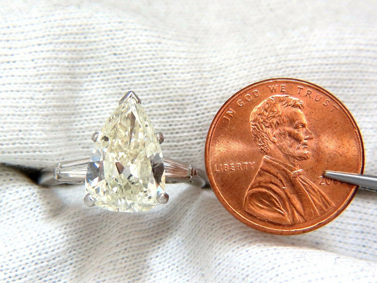 GIA Certified:

 3.77ct. Natural Pear cut diamond ring.

Report #2203856874

L-color

Si-2 clarity

14.29 x 9.33 x 4.45mm

Side (2) Natural Baguette diamonds:

G-color Vs-2 clarity.

Excellent Brilliance.

Platinum

6.1 grams.

Depth: 8mm

current