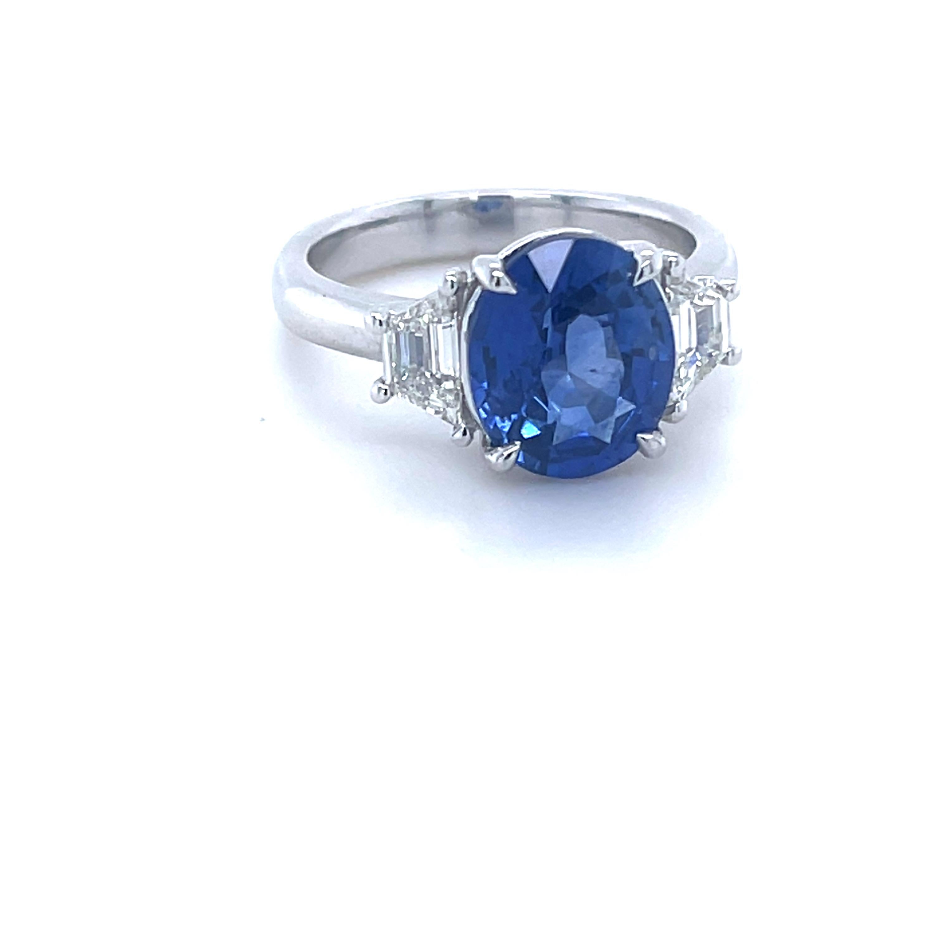 GIA Certified Oval Ceylon Sapphire weighing 3.80 carats
Measuring (10.25x8.62x5.27) mm
Trapezoid Diamonds weighing .46 carats
Set in platinum