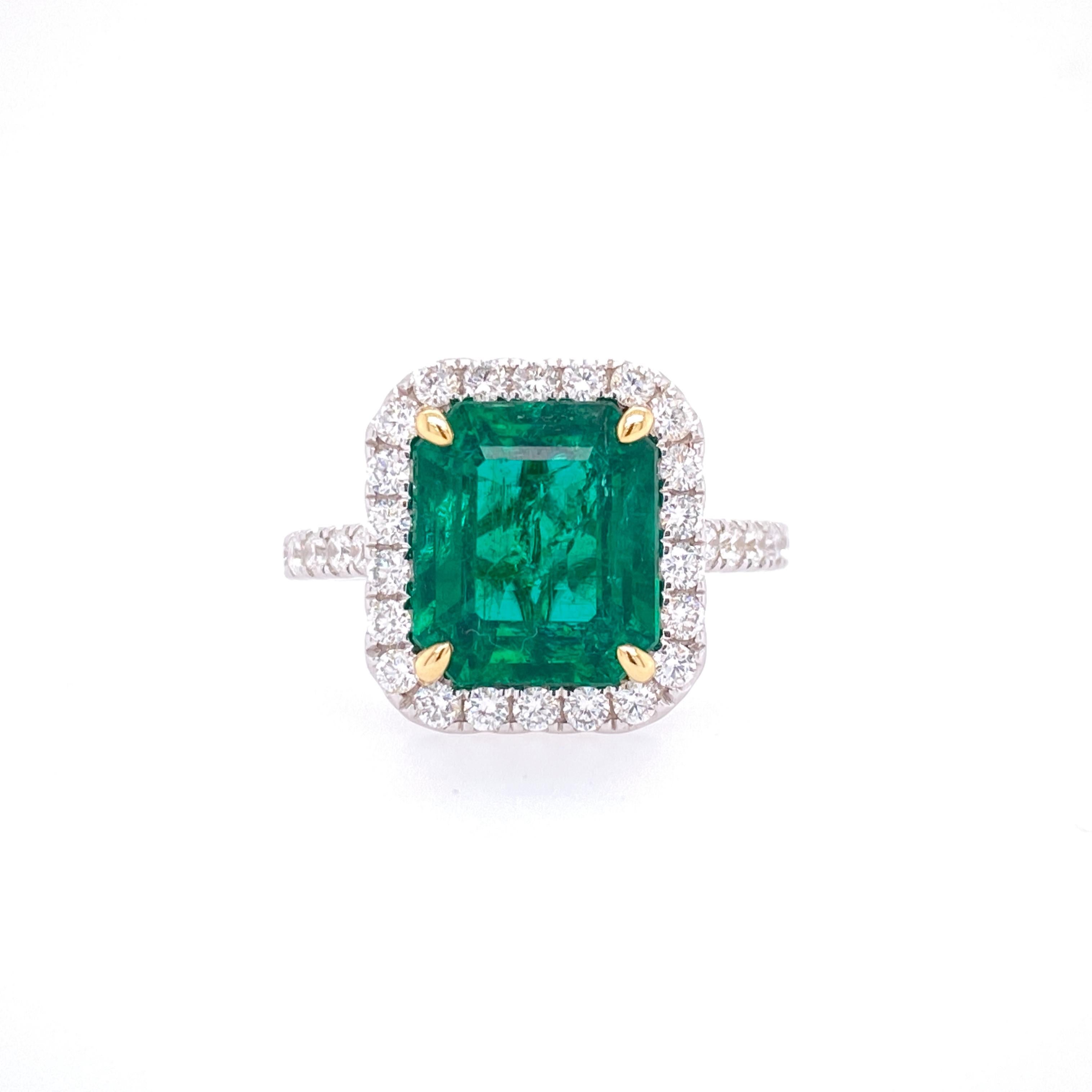 This stunning Cocktail Ring features a beautiful GIA Certified 3.80 Carat Emerald Cut Emerald with a Diamond Halo, that sits on a Diamond Shank. This Ring is set in 18K White Gold, with 18K Yellow Gold prongs on the center stone. 
Total Diamond