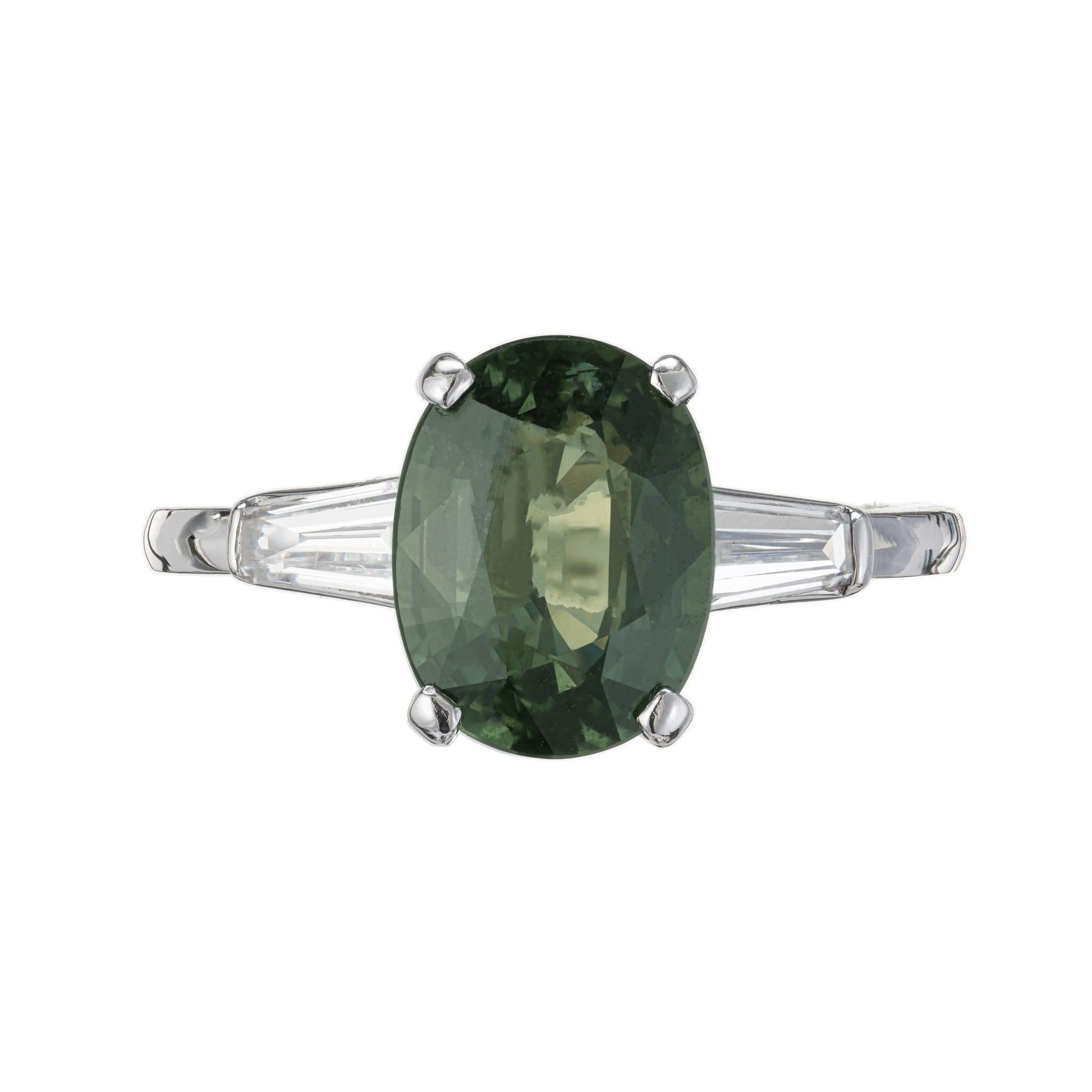 Art Deco 1930's, Sapphire and Diamond engagement ring. GIA certified oval, natural green sapphire set in a platinum three-stone setting with 2 tapered baguette side diamonds. This green sapphire is certified, no heat and no enhancements. The