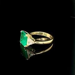 GIA Certified, 3.92ct Step Cut Green Emerald and Diamond Ring