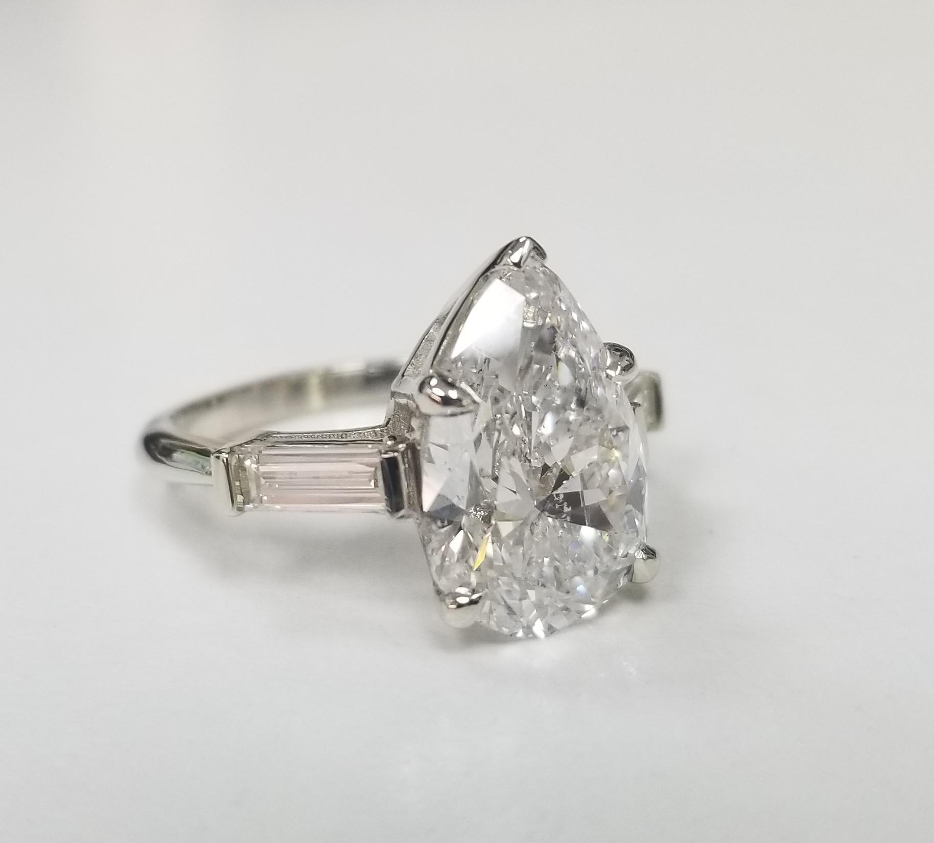 GIA Certified 3.95cts. Pear shape Diamond set in 14k white gold w/ 2 Baguettes weighing .50pts. , containing 1 pear shape diamond; color 