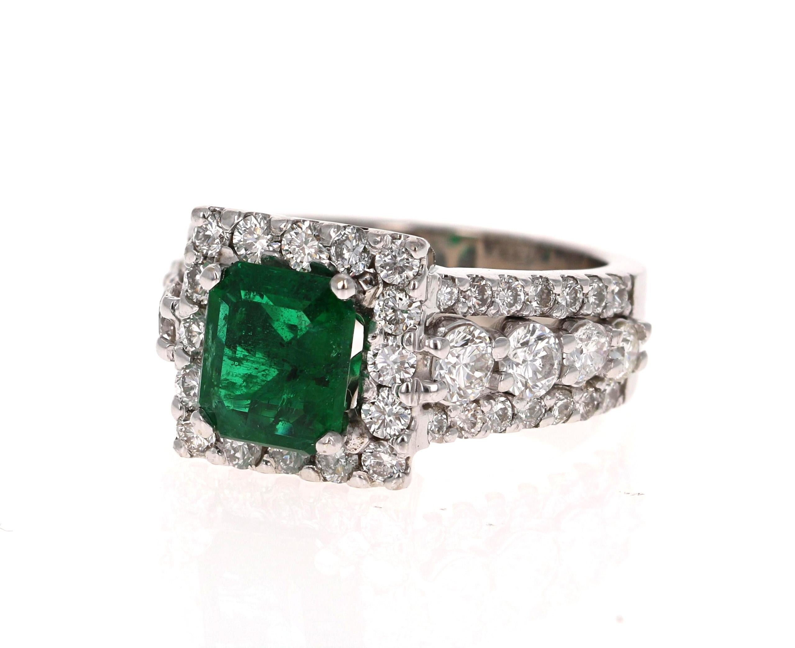 A beautiful modern classic setting holding a magnificent natural Emerald that weighs 1.72 Carats. The emerald is a natural green beryl with an emerald-step cut and the measurements are approximately 8 mm x 7 mm. This gorgeous ring also has 52 Round