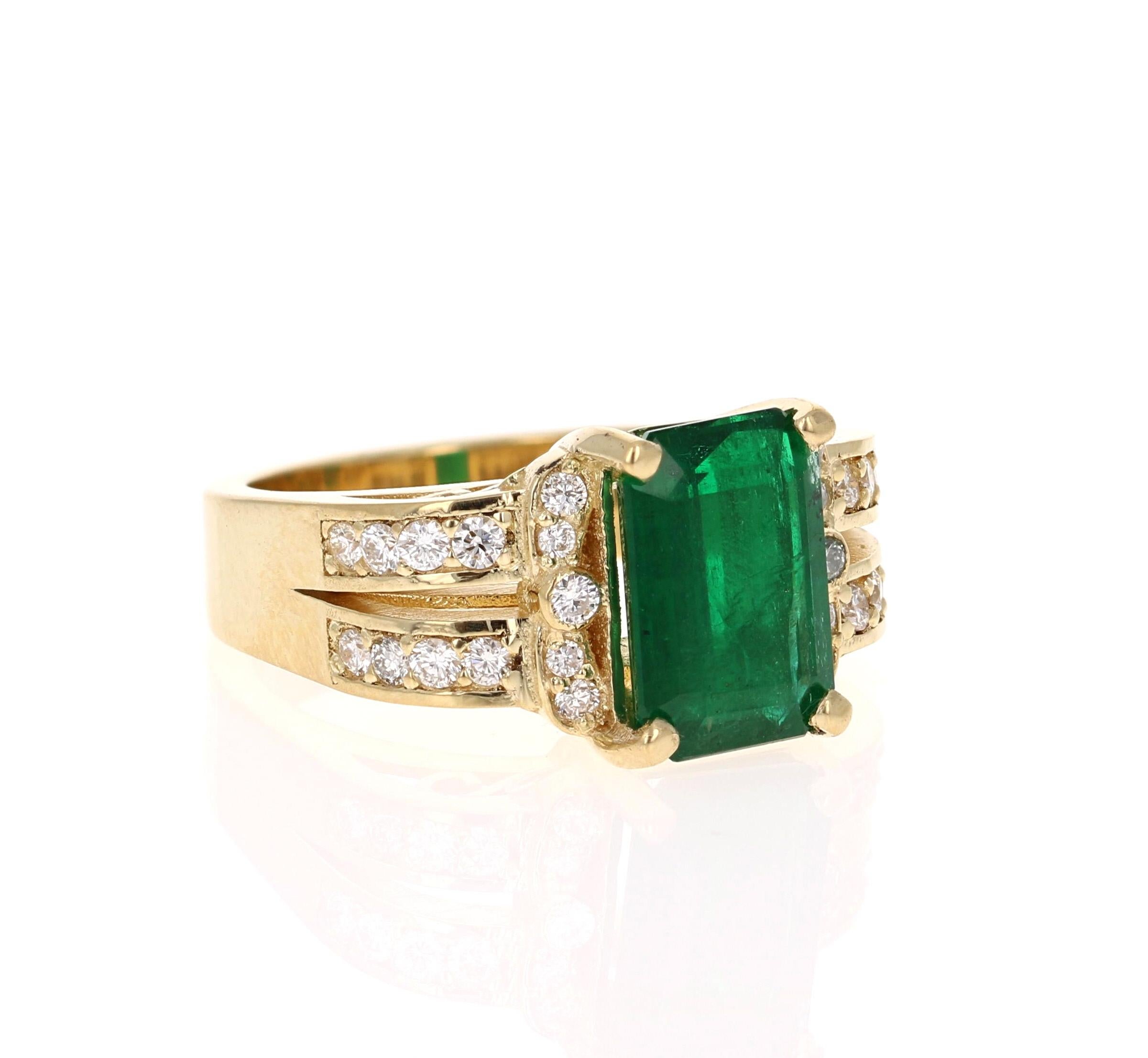 Cette magnifique bague est ornée d'une grande émeraude vert foncé sertie au centre de l'anneau et pesant 3,43 carats.  L'émeraude est entourée de 26 diamants ronds pesant 0,53 carats. (Clarté : VS, Couleur : H). Le poids total en carats de la bague