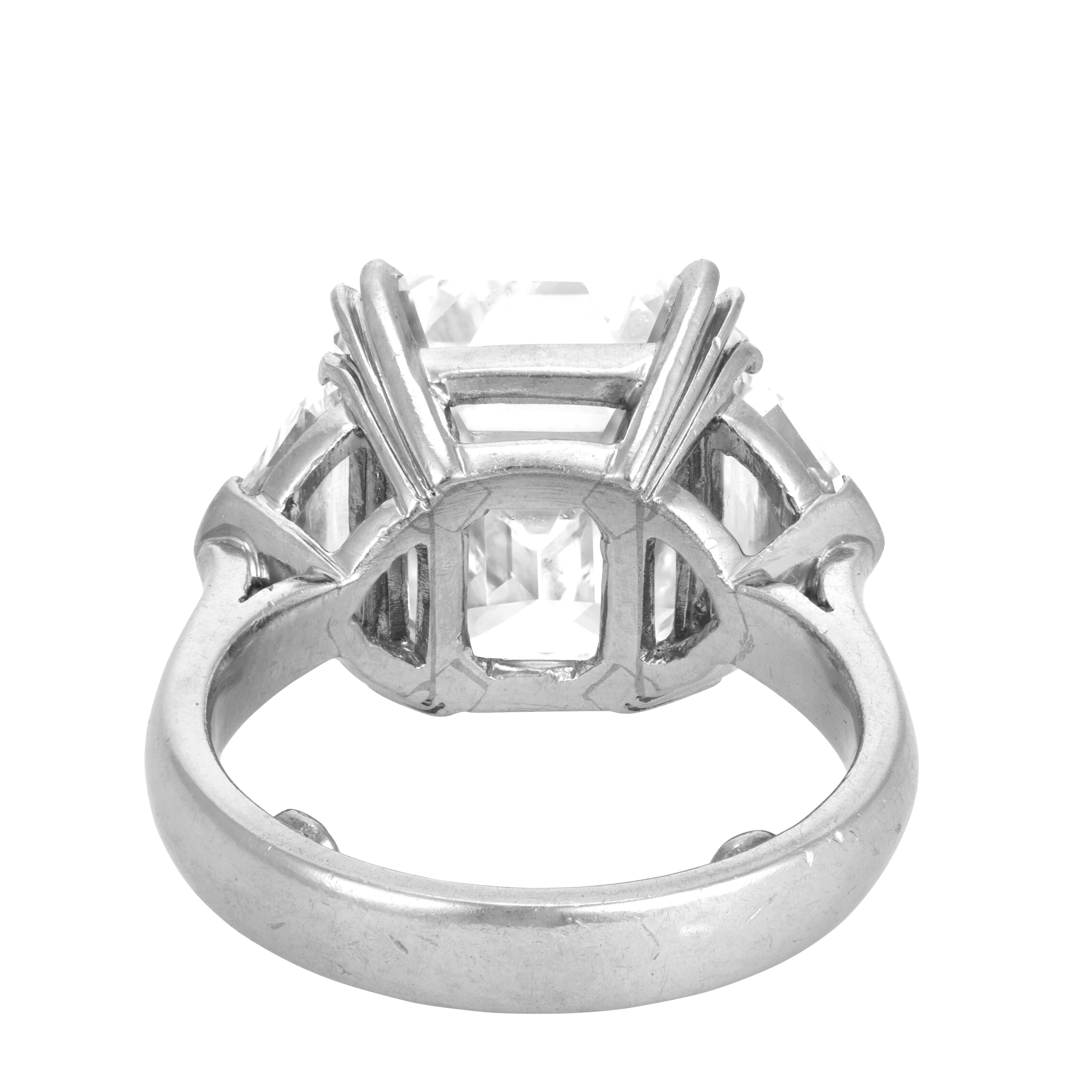 This stunning platinum ring showcases a remarkable 4-carat square-cut diamond as the centerpiece, flanked by beautifully matched trapezoid diamonds on either side, creating a sophisticated and balanced design. The center diamond, certified by GIA,