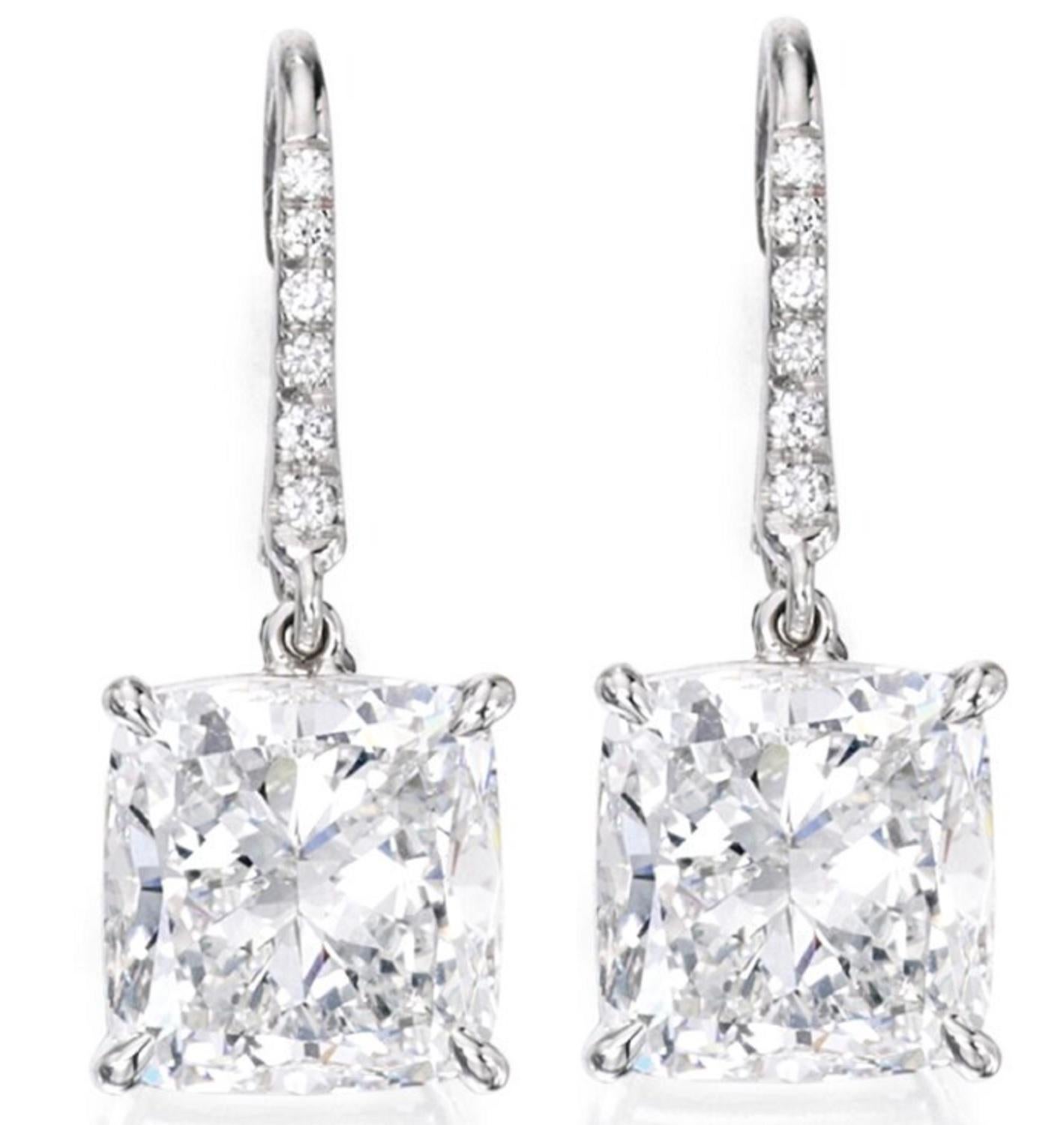 This exquisite diamond dangle earrings are composed by two GIA Certified 4.40 Carat Cushion Modified Brilliant Cut Diamonds with great sparkle. The lovely earrings are set with a pave of natural diamonds and platinum mounting the diamond sum approx.