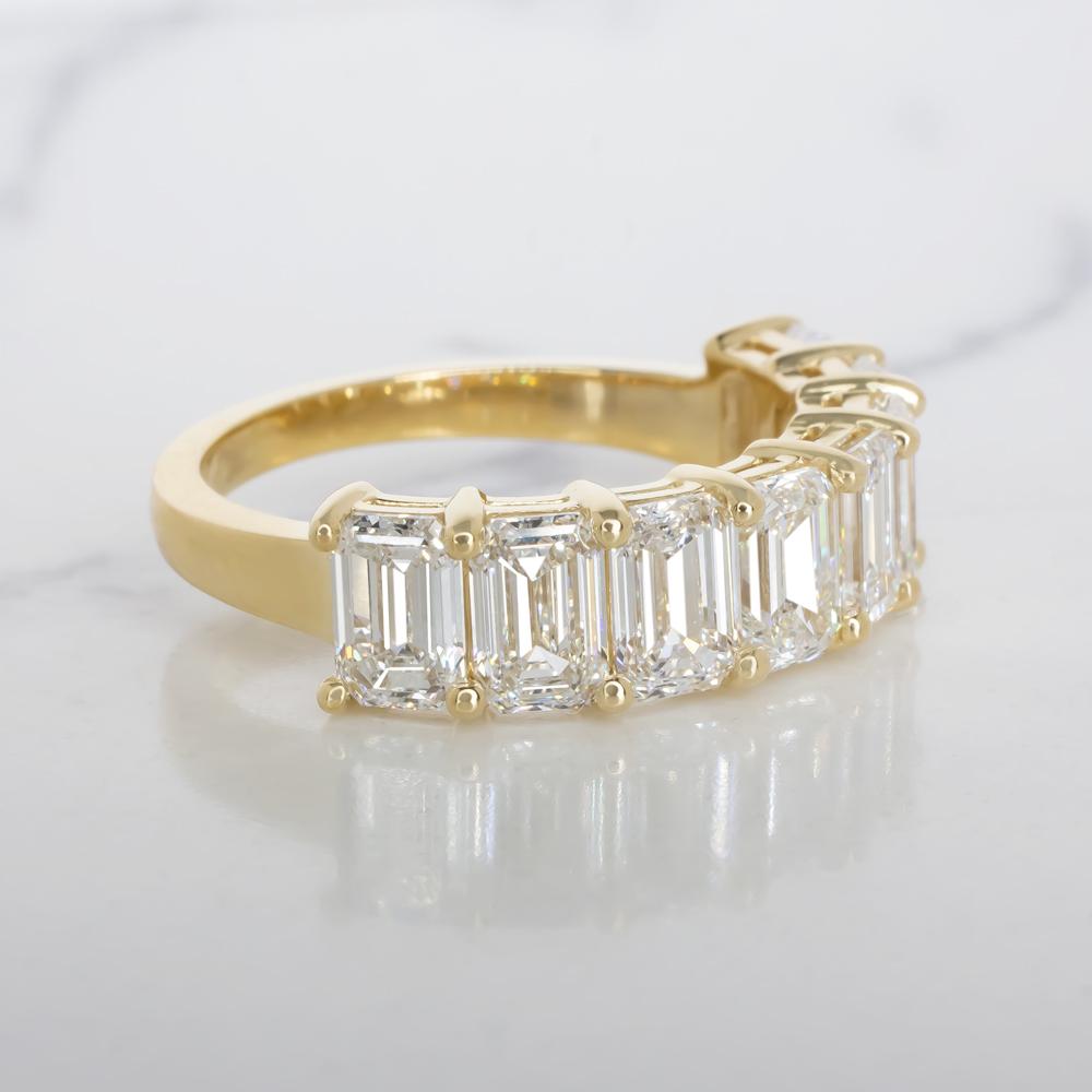 Elevate your jewelry collection with this extraordinary GIA Certified 4 Carat Emerald Cut Diamond Band Ring, a true embodiment of luxury and sophistication. 

The emerald cut, known for its timeless elegance and sleek lines, accentuates the