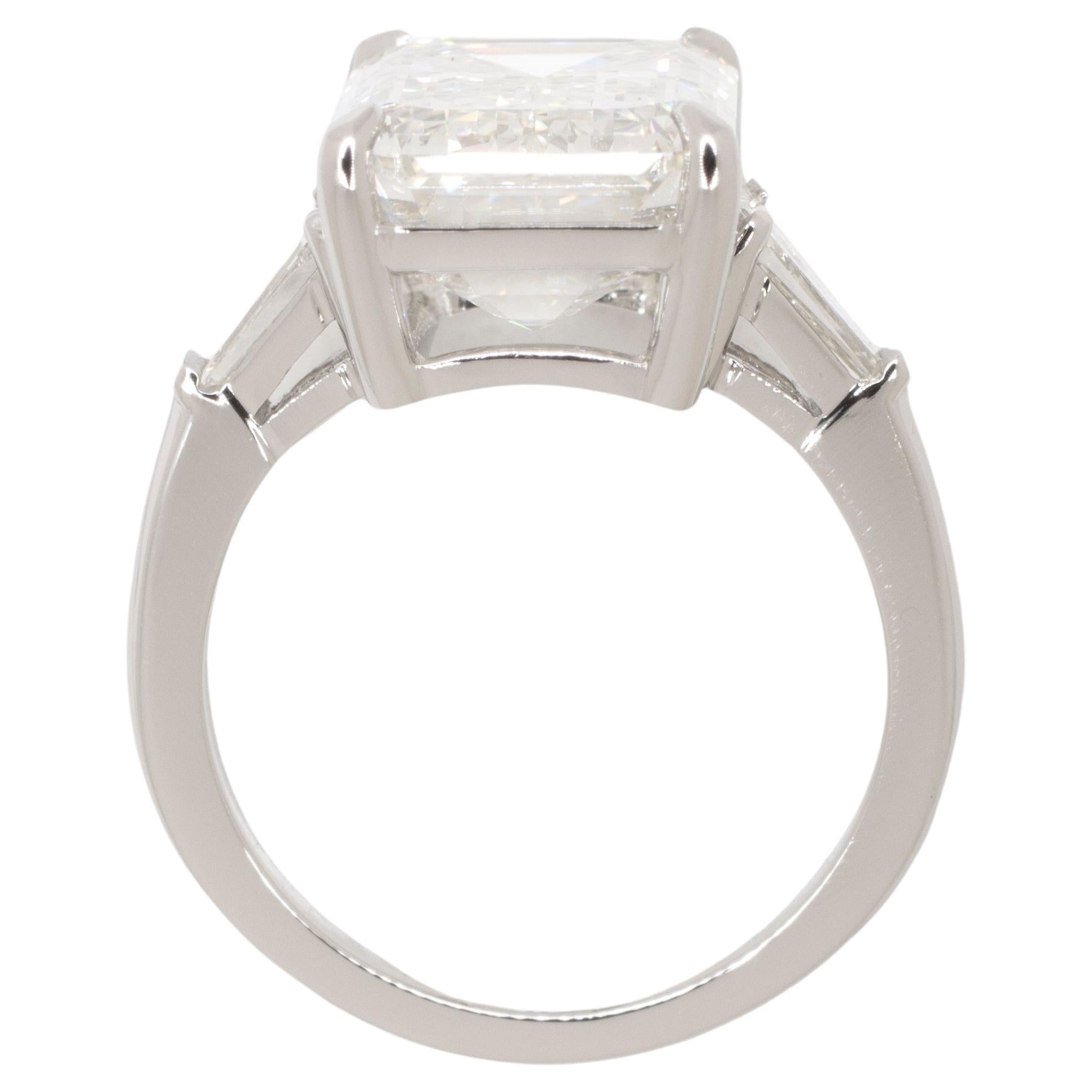 Elevate your style with the timeless elegance of this GIA Certified 4 Carat Emerald Cut Diamond Platinum Ring, accentuated by two tapered baguette diamonds. At its core, this exquisite ring features a stunning emerald-cut diamond, certified by the