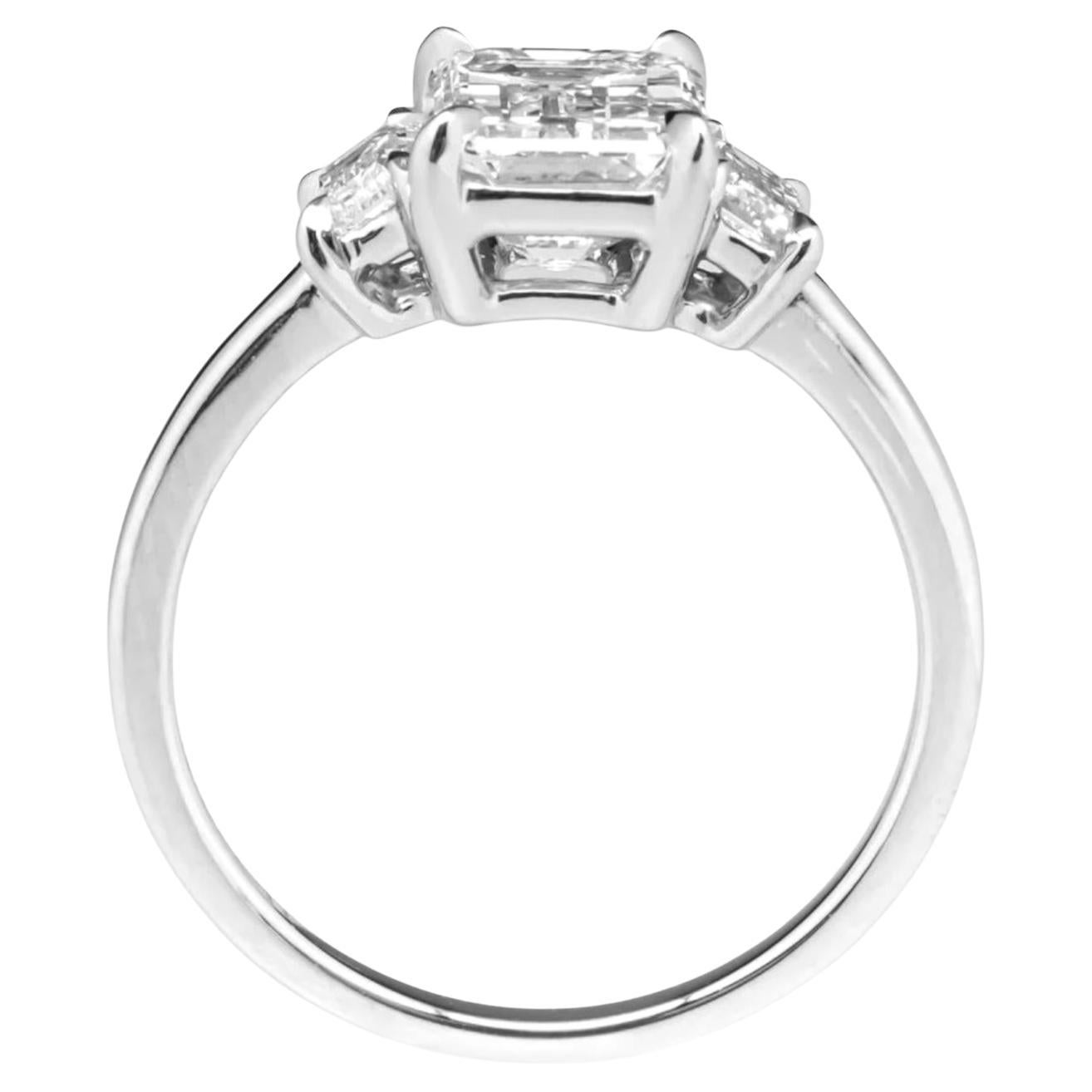 This extraordinary cocktail ring features a breathtaking GIA-certified 4 carat emerald cut diamond, set in a timeless platinum mounting flanked by two elegant tapered baguette side stones. The center stone boasts an exceptional E color and VS1