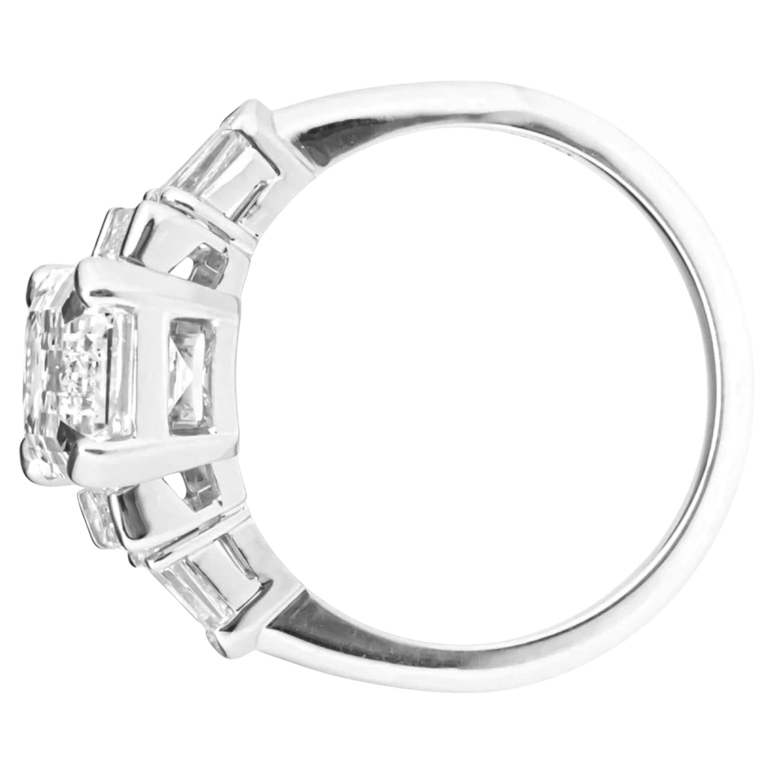 This spectacular engagement ring is centered with one  emerald cut diamond, weighing 4.02 carats, that is four-prong set. The shoulders of the ring are each accented with one (1) channel set baguette cut diamond, and one (1) prong set shield cut