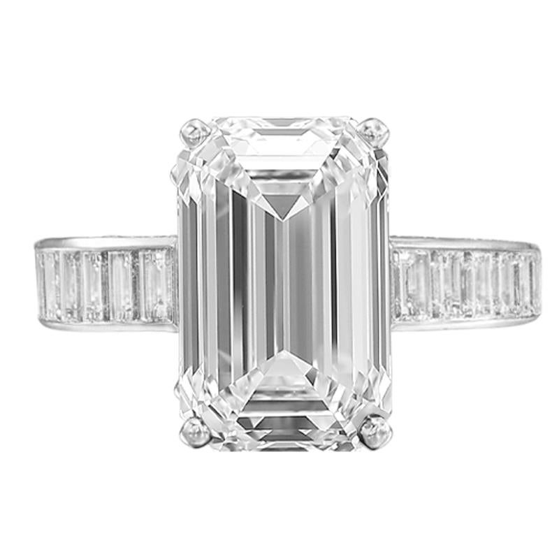 This exquisite ring showcases a breathtaking 4.05 carat emerald cut diamond, GIA-certified for its superior quality. 

Set in luxurious 18K white gold, the centerpiece diamond boasts an H color grade and VS1 clarity, ensuring a near-flawless