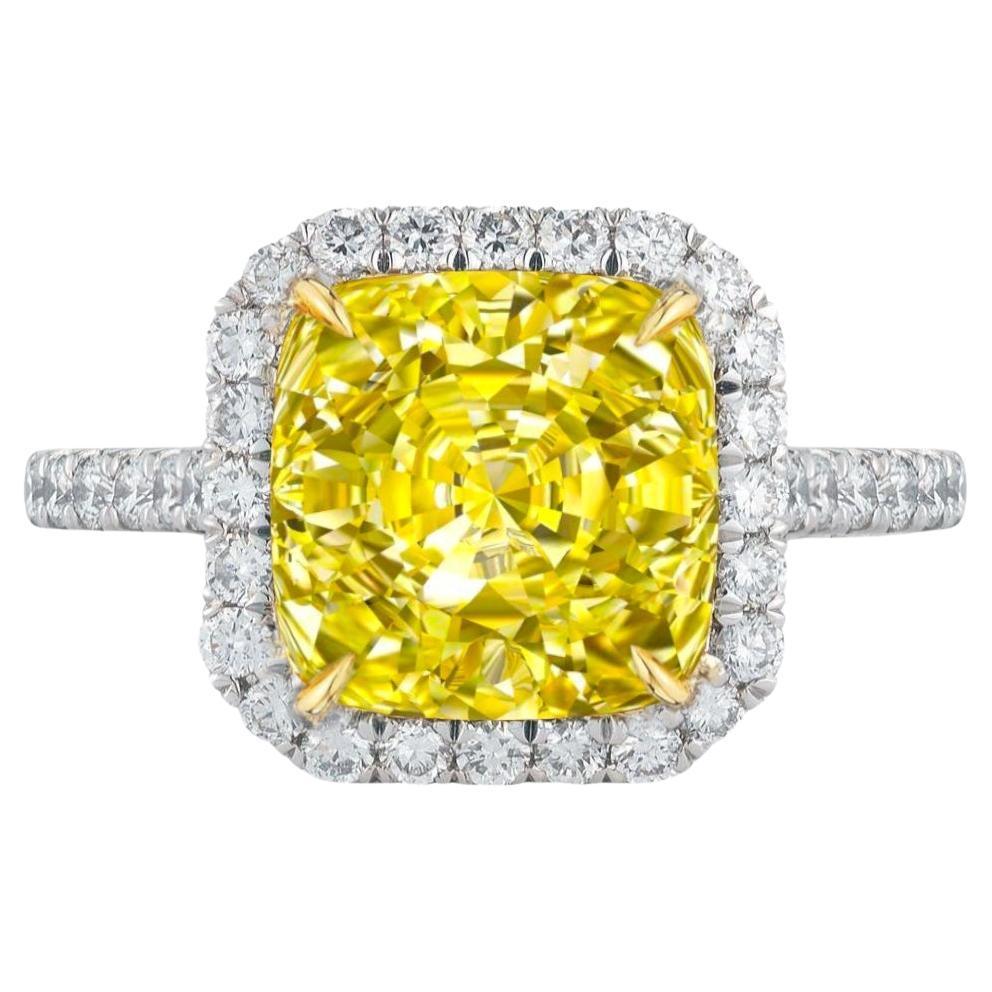 The center diamond, known for its pure clarity and vibrant yellow hue, is encircled by a halo of sparkling pavé diamonds.

The setting is made in platinum and 18k yellow gold. 

This custom ring is a perfect blend of modern elegance and timeless