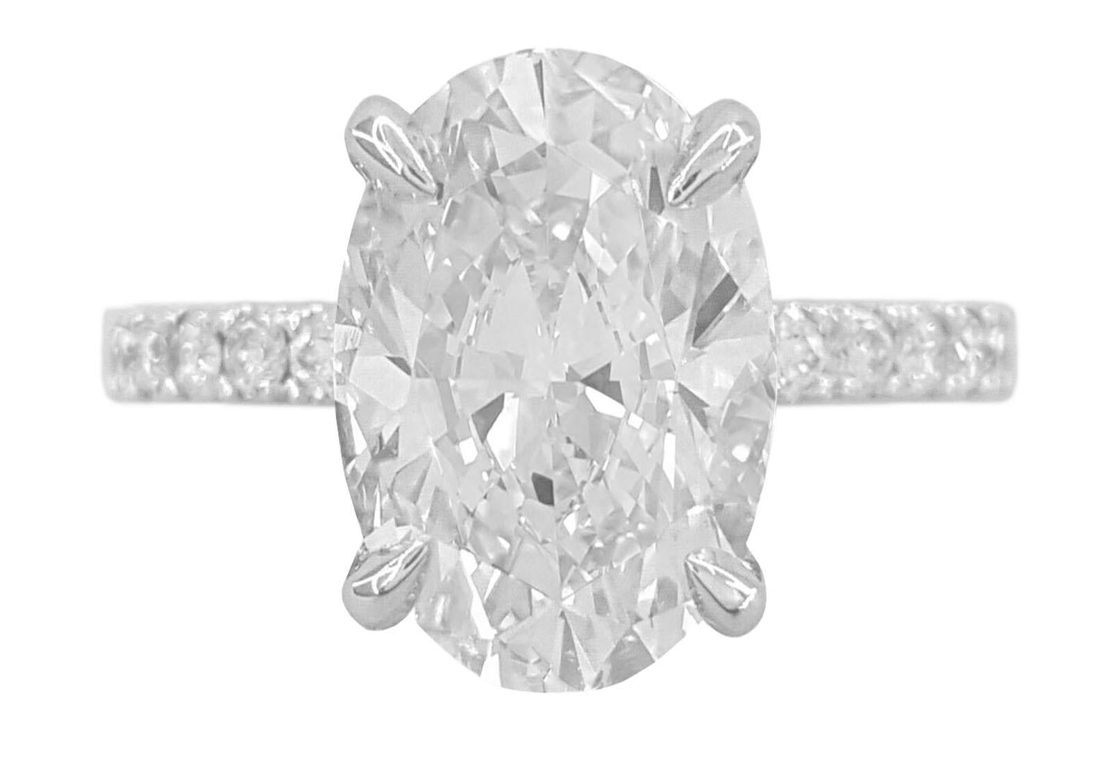 This exquisite 4 carat oval cut diamond ring radiates elegance and brilliance, making it a true statement of sophistication. GIA certified, the center stone boasts a prestigious G color grade is certified VS1 clarity, this gem shines with absolute