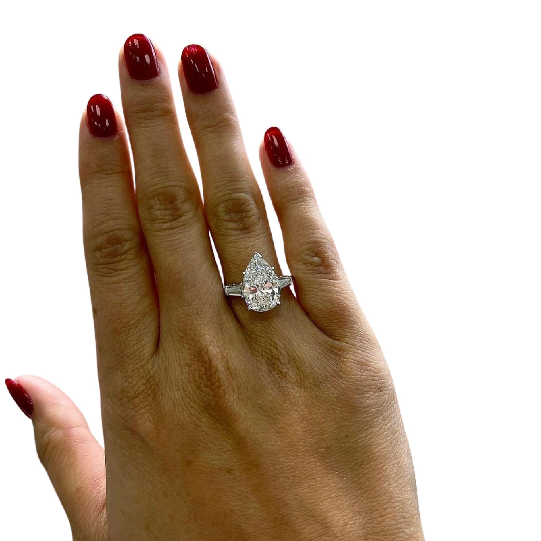 This exquisite ring boasts a magnificent 4-carat pear-cut diamond as its centerpiece, certified by the Gemological Institute of America (GIA) to ensure its exceptional quality and authenticity. The diamond dazzles with a rare D color grade,