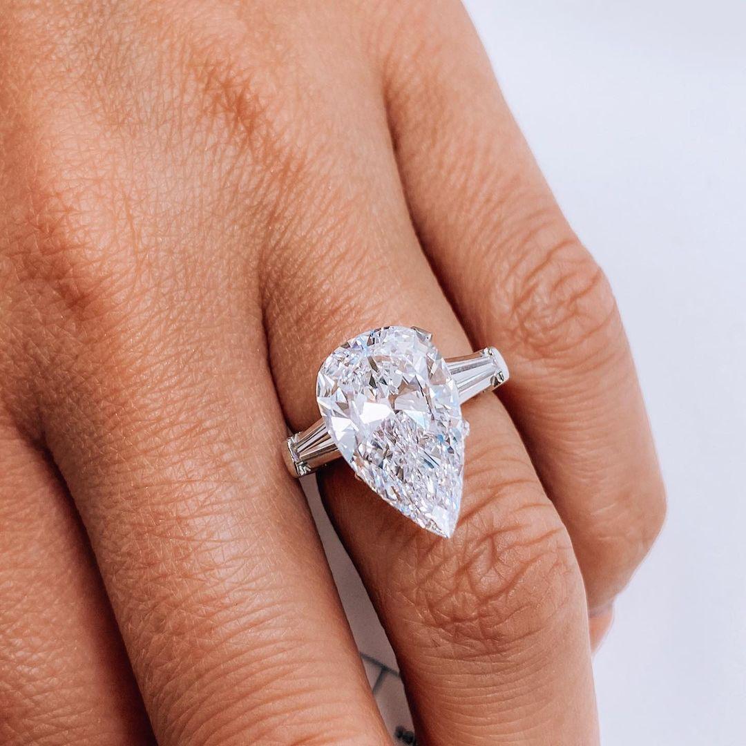 Cette bague de fiançailles raffinée est ornée d'un diamant poire de 4 carats certifié par le GIA, serti dans un luxueux platine, associant des matériaux intemporels à un design exceptionnel. Gracieusement allongée, la forme poire forme une