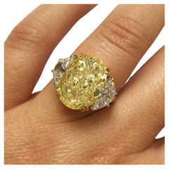 GIA Certified 4 Carat Three-Stone Fancy Yellow Oval Cut Diamond Ring Flawless