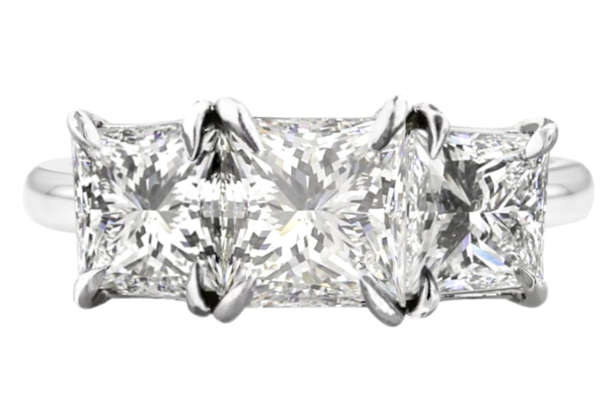 GIA Certified 4 Carat Three Stone Princess Cut Diamond Platinum Ring
The main stone is a 2 carat G color, VS1 in clarity, Square Modified Brilliant diamond.
The side diamonds are both 1.01 carat H color and VS1/VS2 in clarity.
