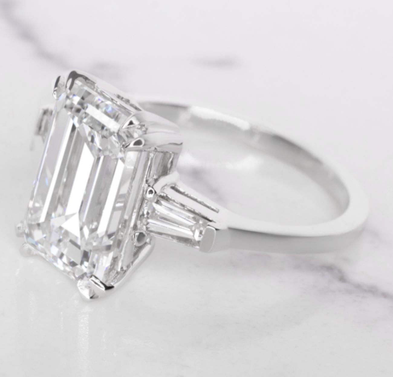 This GIA certified 4.01 carat emerald cut diamond ring is a stunning embodiment of elegance and refinement.  

With a rare color grade of D, the diamond is completely colorless, enhancing its radiant brilliance. Graded VVS2 for clarity, it features