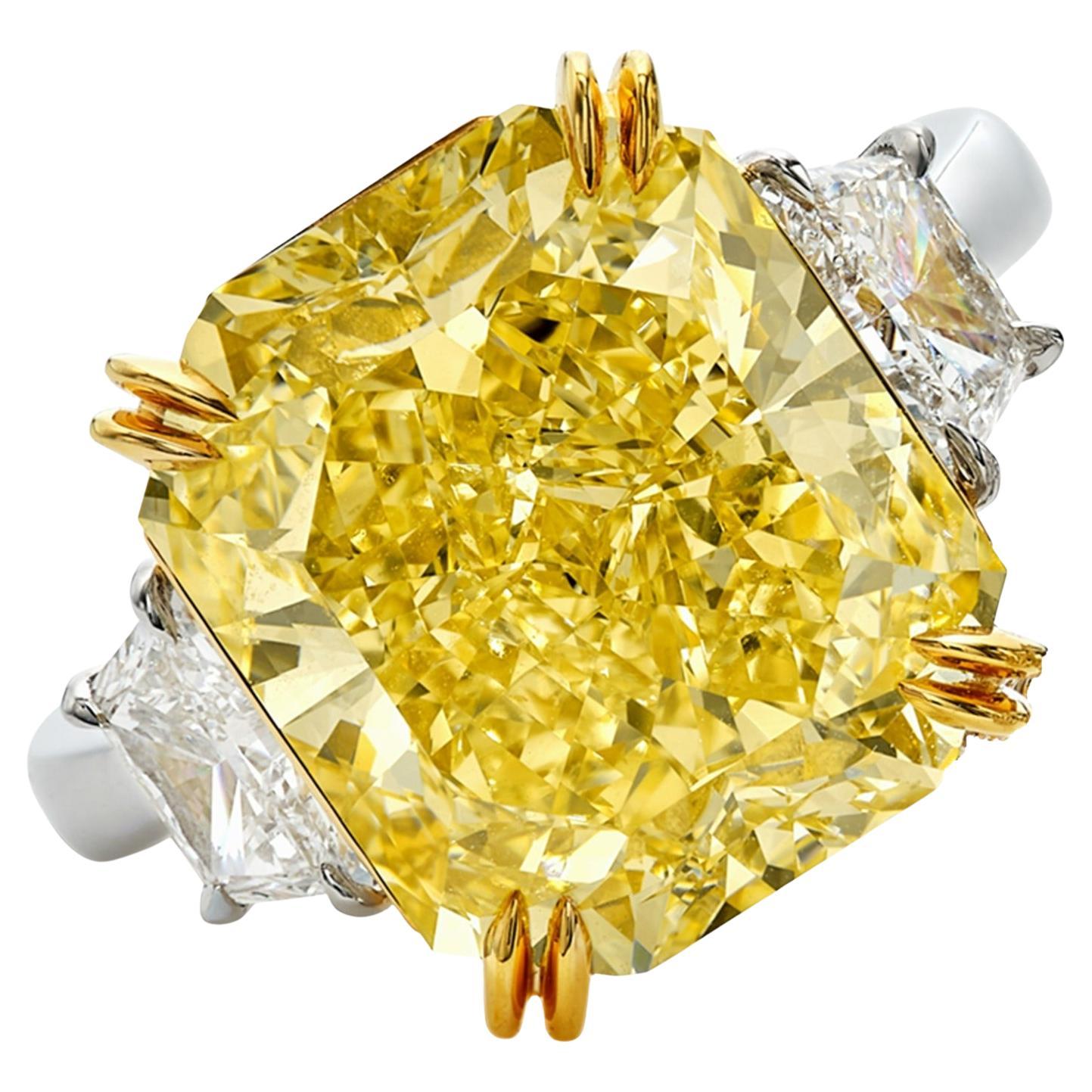 Radiate unparalleled elegance with this GIA Certified 4 Carat Fancy Yellow Cushion Cut Diamond Ring, adorned with trapezoid diamonds on the side. At the heart of this magnificent ring gleams a captivating cushion-cut diamond, certified by the