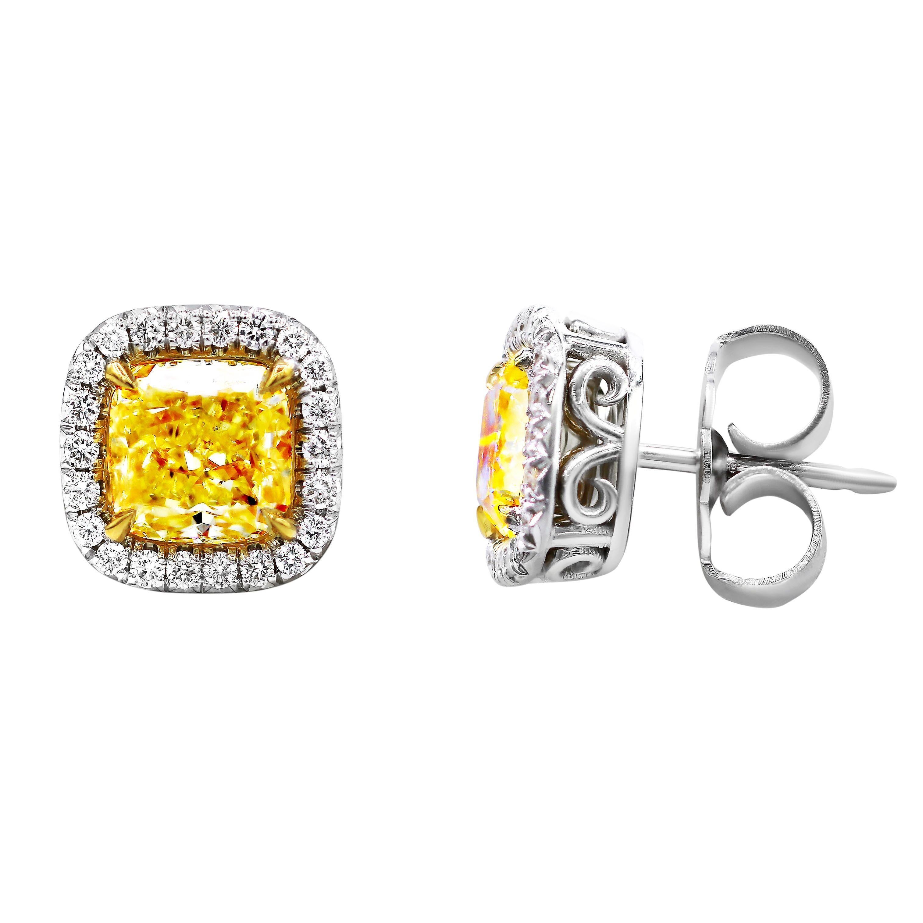 18 karat white and yellow gold halo diamond stud earrings with two GIA certified natural fancy yellow cushion cut diamonds,featuring 2.00 carats/VS2 clarity and 2.00 carats/VS1 clarity and accented by natural round cut diamonds 0.42  total carat