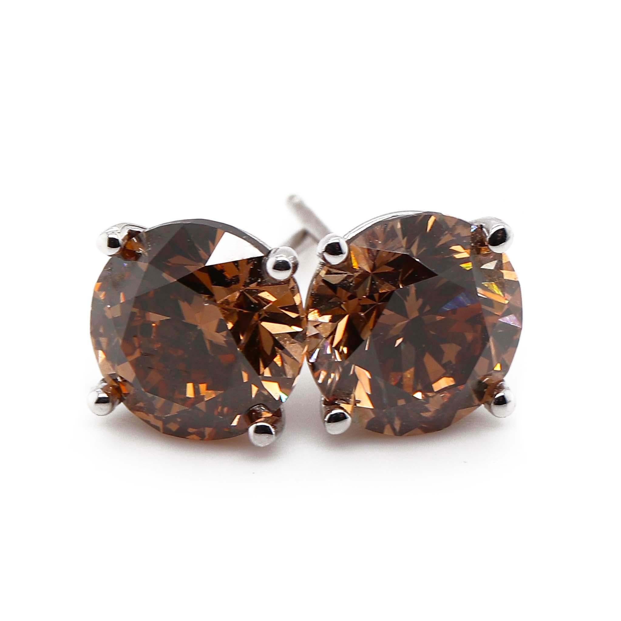 Natural and Fancy 2 Round Diamonds of about 4.00 carats Clarity SI2, I1 and Color Fancy Yellow Brown, Fancy Dark Orangy Brown. Both diamonds are GIA certified (GIA2221382978  GIA2225382975) and are set in a 14k white gold setting. Total weight of