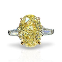 GIA Certified 4.00 Oval Cut Fancy Yellow Diamond Three Stone Ring
