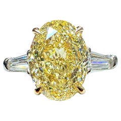 GIA Certified 4.00 Oval Cut Fancy Yellow Diamond Three Stone Ring