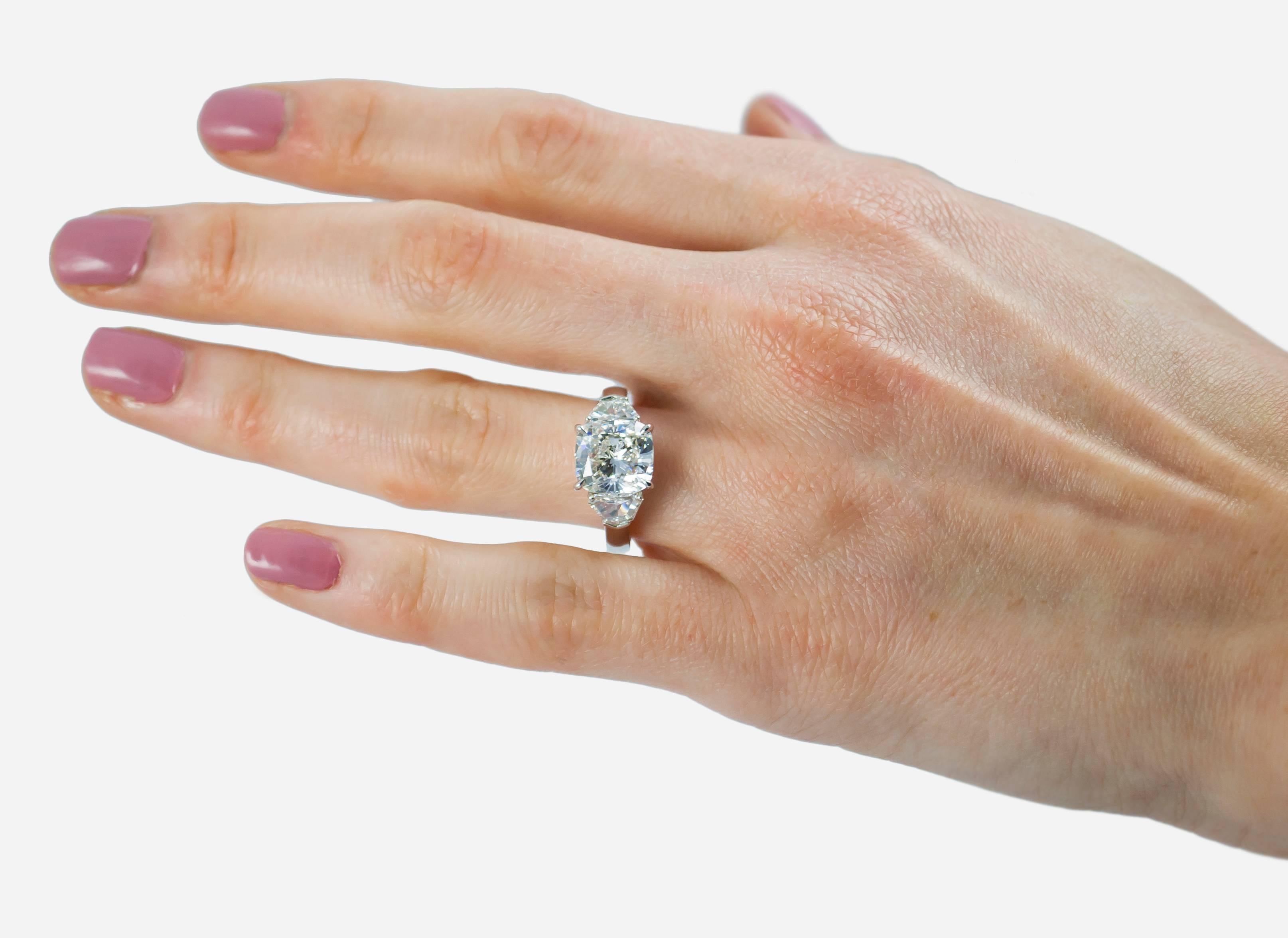 This ring features a J. Birnbach GIA certified 4.01 carat cushion cut diamond, G color and SI2 clarity set in a platinum mounting and flanked on each side by diamond shields weighing 0.84 carats each of G color and VS clarity.

Purchase includes GIA