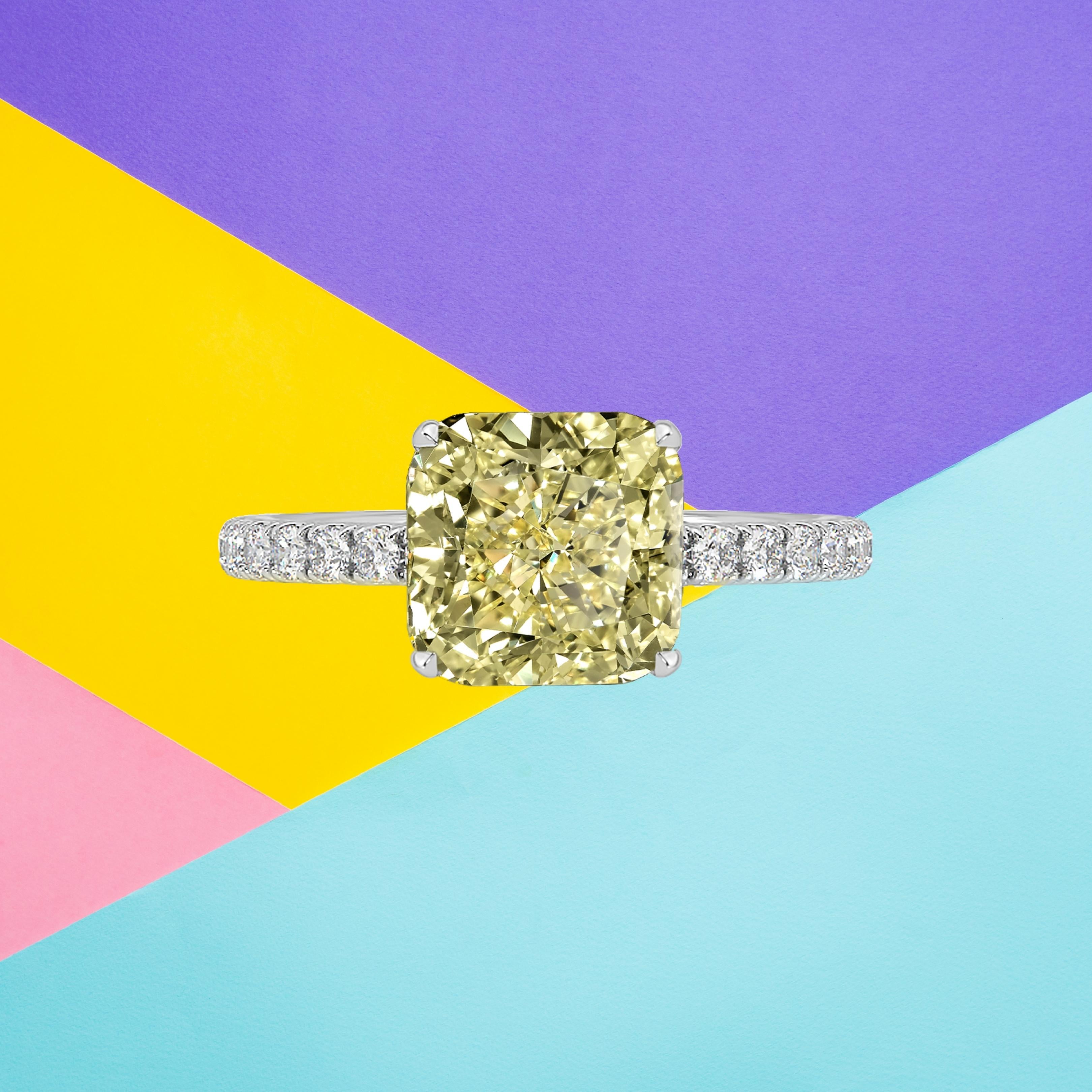 This cushion cut diamond weighs 4.01 carat and is certified 'Fancy Light Yellow' color by the Gemmological Institute of America. The GIA has also assigned a VVS2 grading to the stone. The diamond has been inscribed with the certificate number to