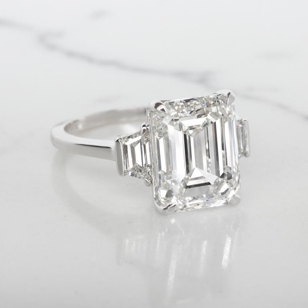 At the heart of this Platinum ring sits a breathtaking 4.01 carat Emerald-cut diamond, certified by the Gemological Institute of America (GIA) as D color and Flawless clarity, a true masterpiece of nature that embodies the pinnacle of diamond