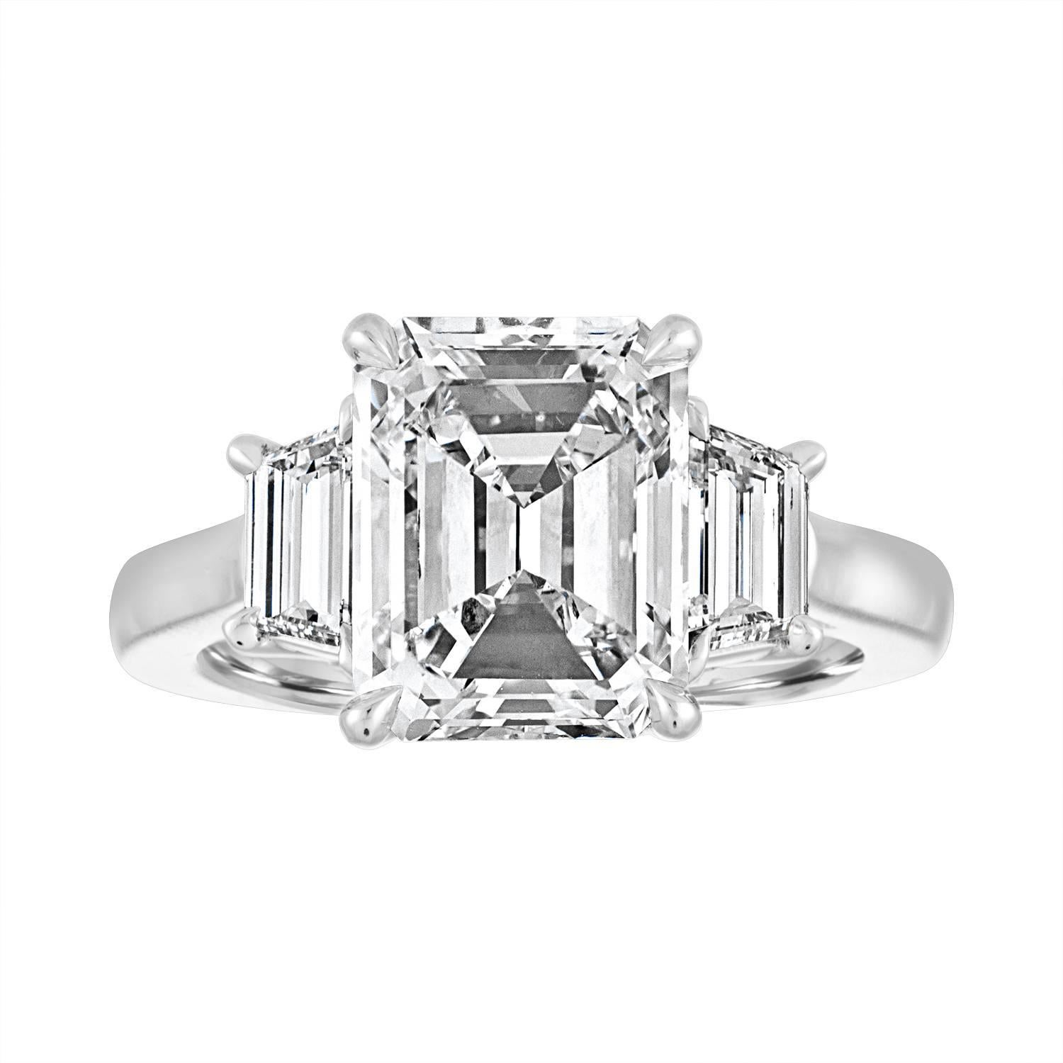 Certified 4.01 Carat Emerald Cut J in Color and SI2 in Clarity. The Center is set in Three Stone Ring. The Mounting is Hand Made Platinum Mounting.
The Step Cut Diamonds are 0.72 Carat Total Weight. 
The GIA certificate number is 6173839485.
