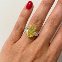 GIA Certified 4.01 Carat Fancy Yellow VS1 Oval Diamond Three Stone Ring