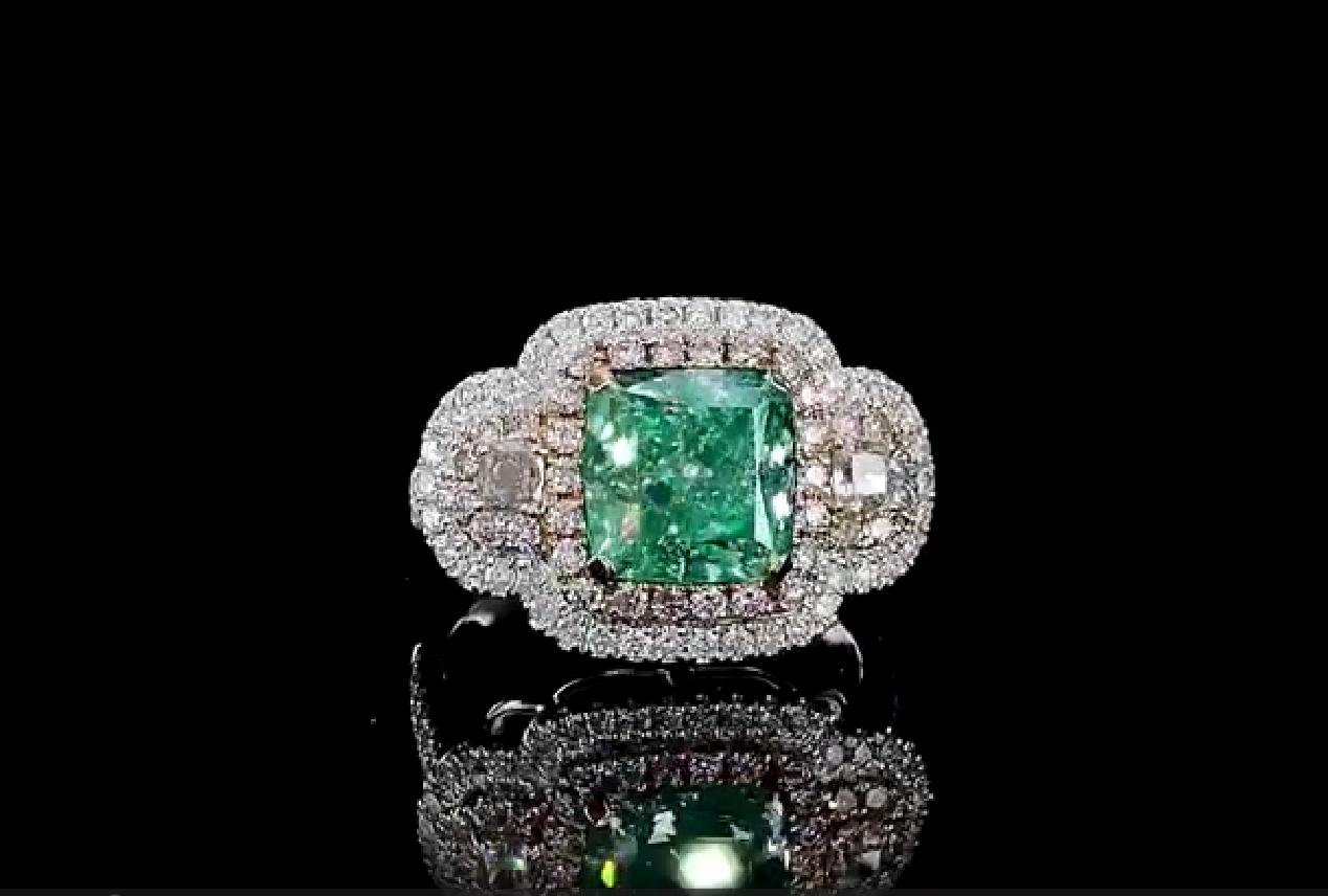 18kt white gold ring with diamonds
  
  Gold colour & karat: White gold 18kt
  Weight: 5.72 grams
  
  Set with-
  Stone type: Diamonds
  Shape: Cushion
  Carat: 4.01 ct
  Colour: Light Green Yellow
  Clarity: I2
  
  Surrounding Stones: Diamonds
