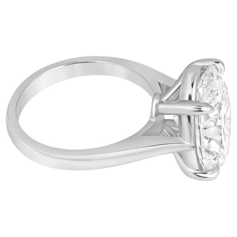 This stunning GIA-certified solitaire ring showcases a remarkable 4.01 carat oval-cut diamond, exuding timeless beauty and sophistication. The sleek 18K white gold setting enhances the diamond’s brilliance, adding a refined touch that makes this
