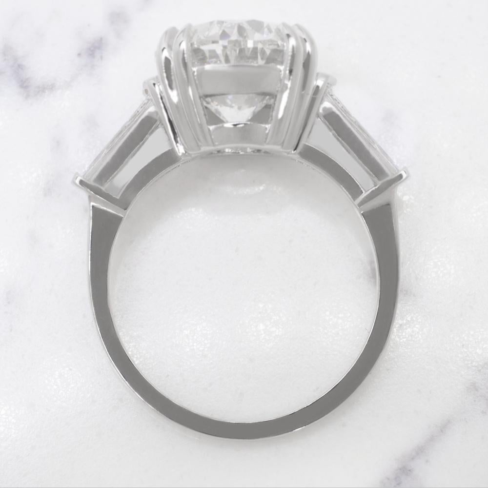 This exquisite engagement ring showcases a 4.01 carat oval diamond as it's centerpiece, radiating timeless elegance and brilliance. 

The diamond is GIA certified, ensuring its authenticity and exceptional quality. With a color grade of D, it is