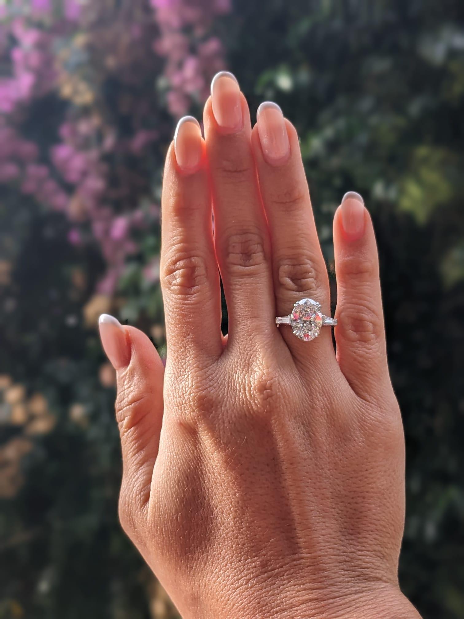 Contemporary GIA Certified 4.01 Carat Oval Diamond D Color Ring with Tapered Baguette For Sale