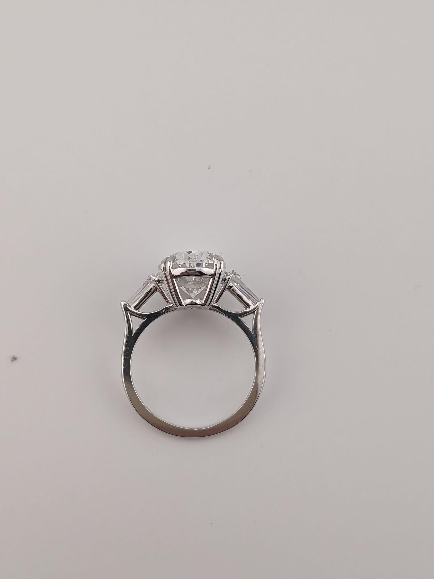 Oval Cut GIA Certified 4.01 Carat Oval Diamond D Color Ring with Tapered Baguette For Sale