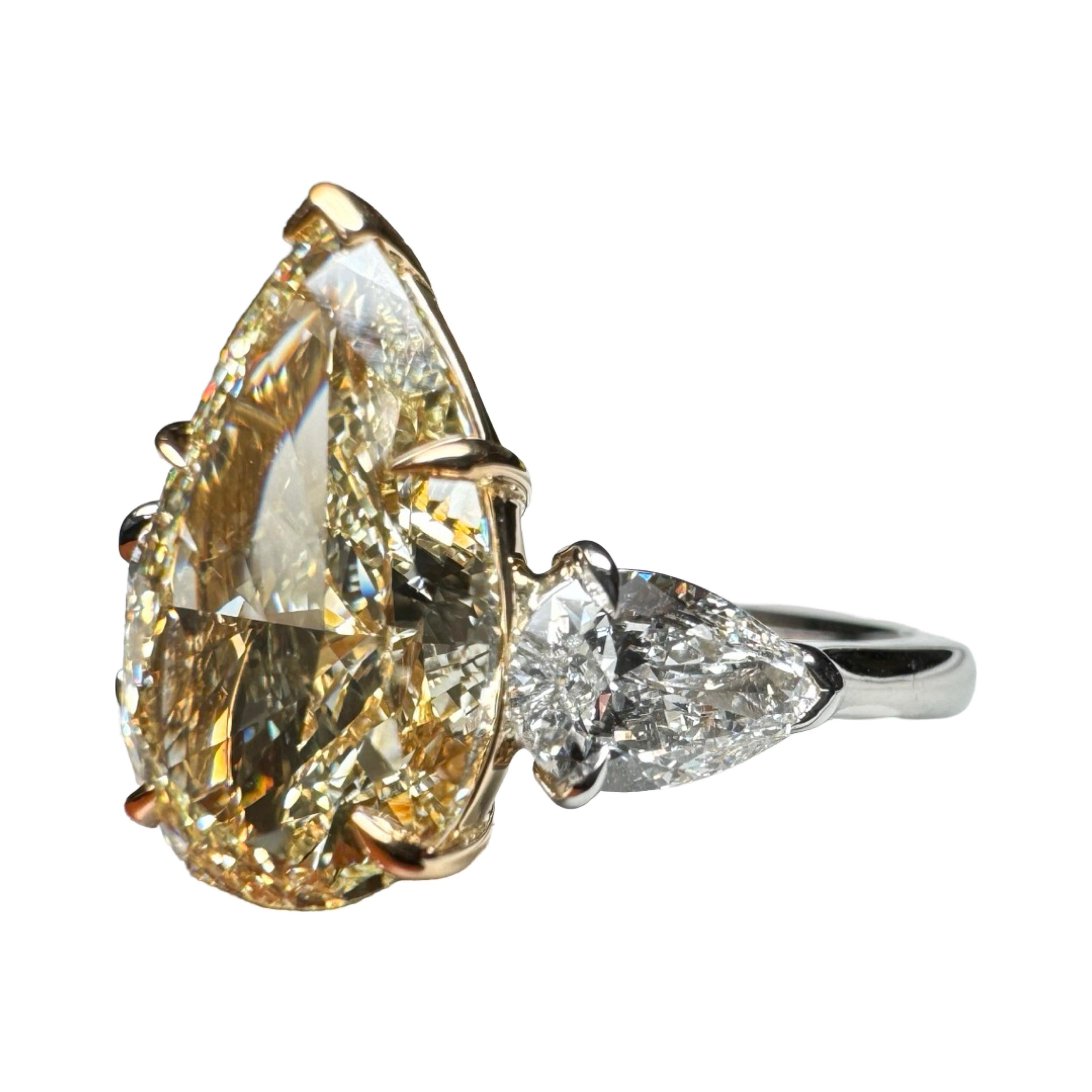 A GIA Certified 4.01 Carat Pear Cut Yellow Diamond 3 Stone Ring designed for a Pear Cut lover!

Our 3 stone ring features a 4 carat, GIA Graded, Light Yellow Diamond with two High-Colorless Pear Shape Diamond Side Stones.
Center stone was Graded by