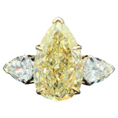 GIA Certified 4.01 Carat Pear Cut Light Yellow Diamond 3 Stone Ring