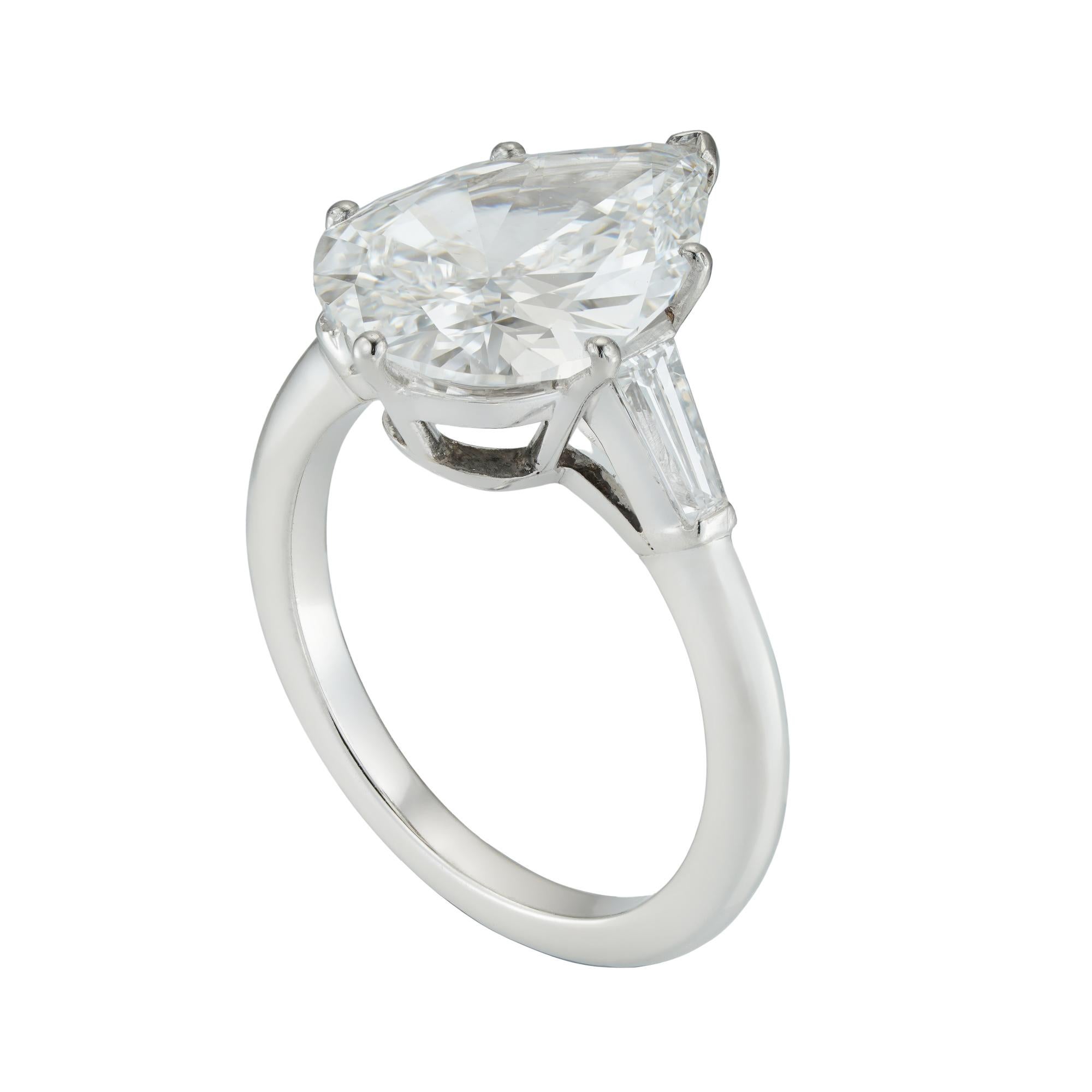 A pear-shape solitaire diamond ring, the pear-shaped diamond weighing 4.01 carats accompanied by GIA report stating to be of E colour and VS1 clarity, six claw-set between two small taper baguette-cut diamonds estimated to weigh a further total of