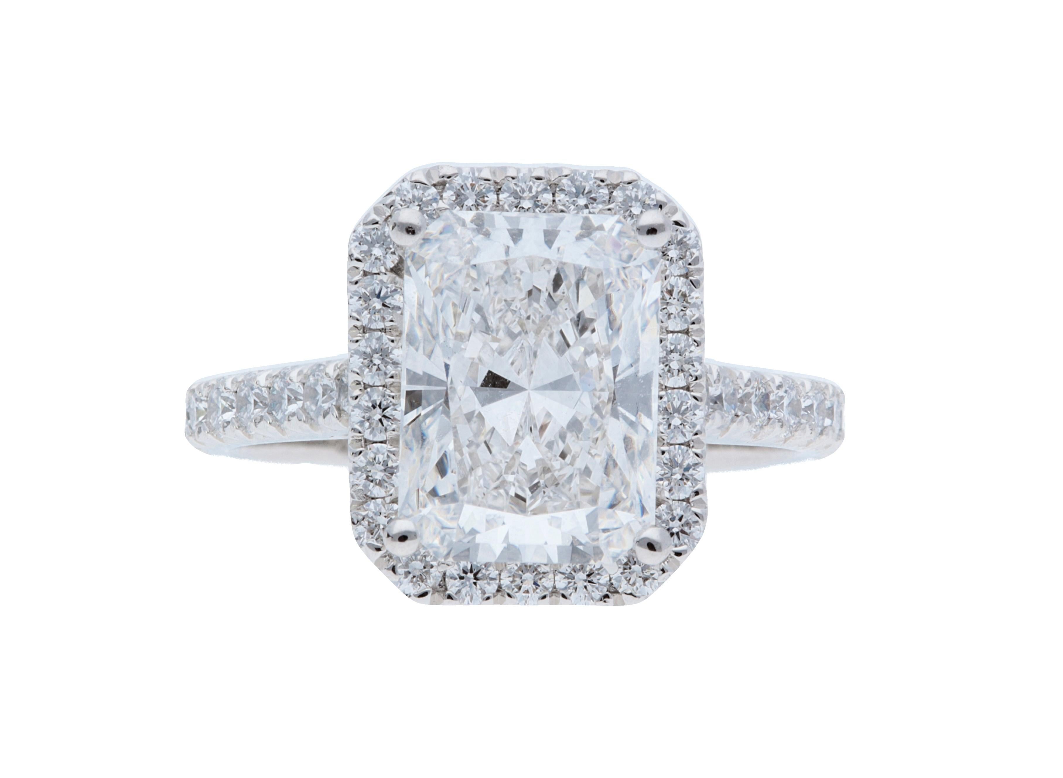 A Sofer Jewelry original. GIA certified 3.30 carat F VS1 radiant diamond set in platinum halo ring with 0.71 carats of weight diamonds. Size 6.5.