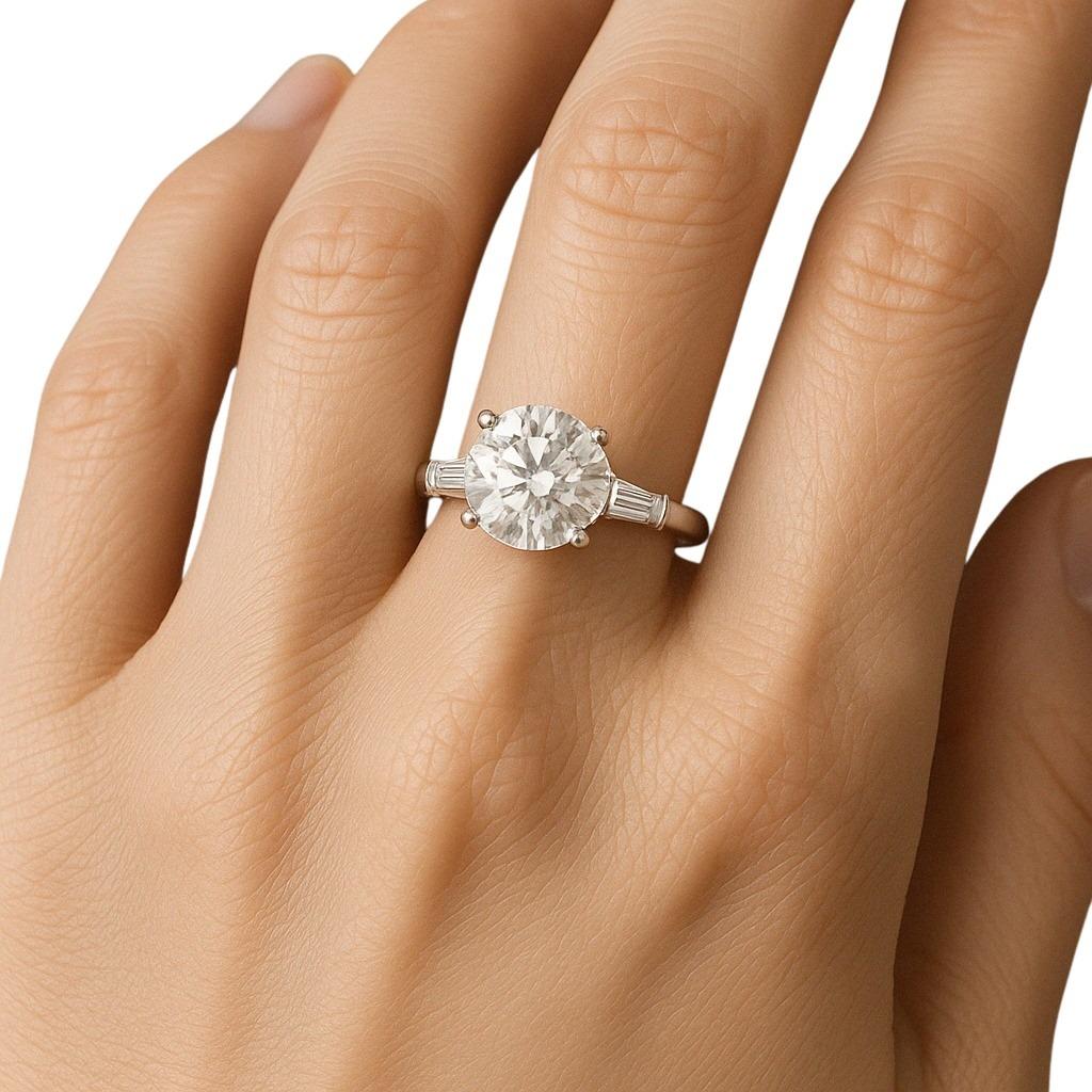 This timeless engagement ring features a GIA certified 4.01 carat round cut diamond set in platinum, offering classic brilliance and enduring appeal. 

The centerpiece displays a warm K color grade, adding a soft, romantic glow to its appearance.
