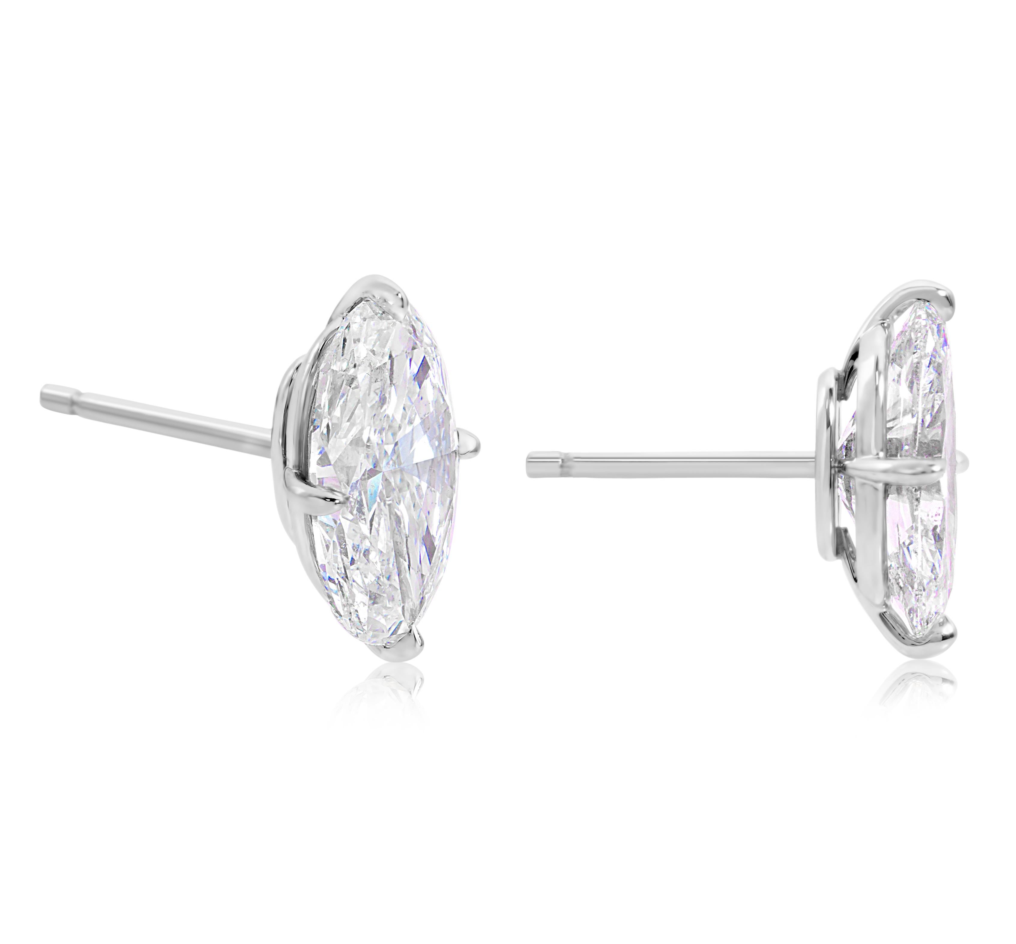 A remarkable pair of stud earrings, featuring two GIA certified elongated oval brilliant cut diamonds: 2.01 carats with H color and 2.00 carats with I color, both have SI2 clarity. Each stud is set on a four-prong compass setting. Finely made with