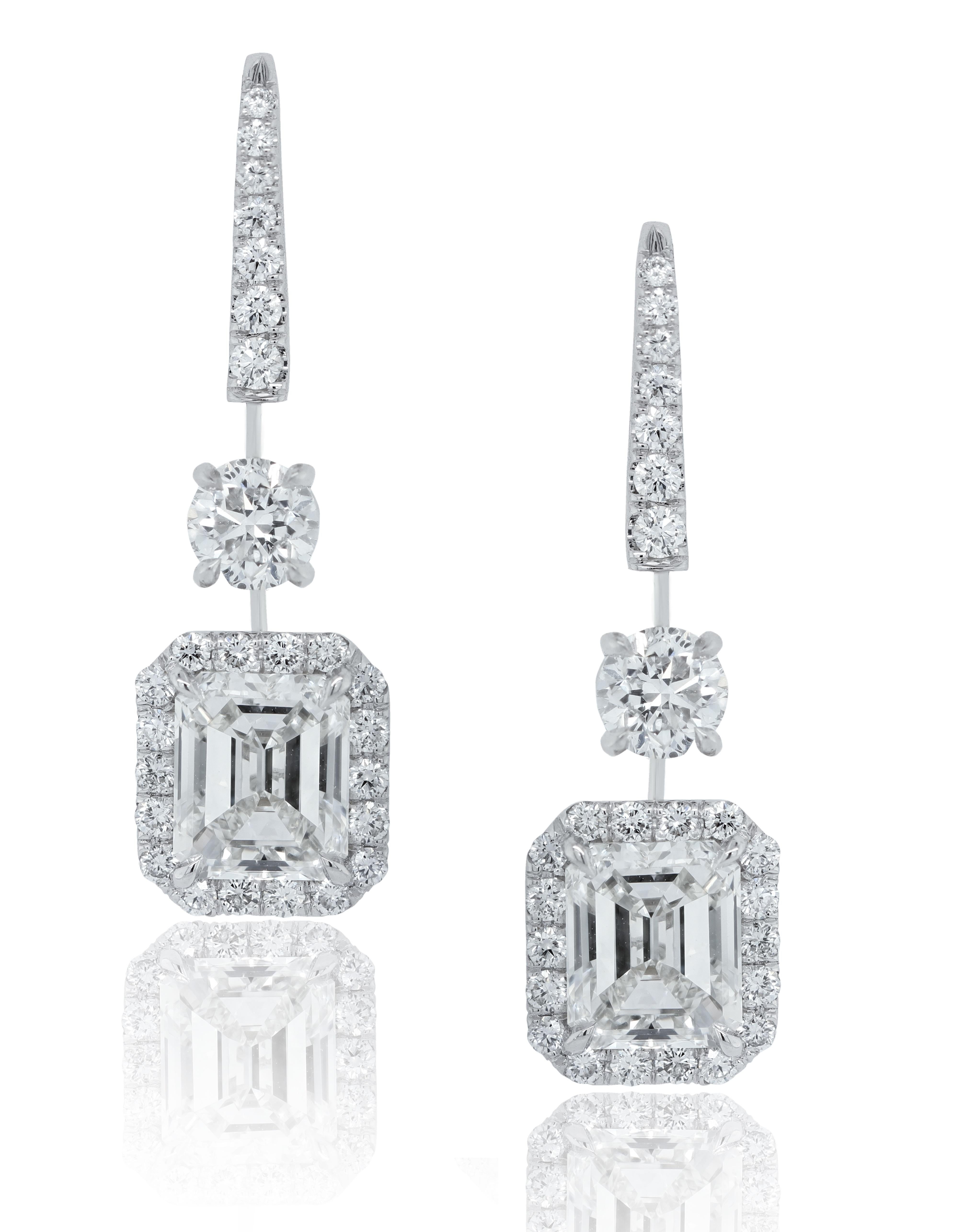Elegant pair of GIA Certified diamond hanging earrings, features 4.01 Carats of GIA Certified,  I VVS1 & VVS2 GIA#2326536684 & 2294984675, surrounded by 2.00 Carats of VS quality round cut diamonds. 
